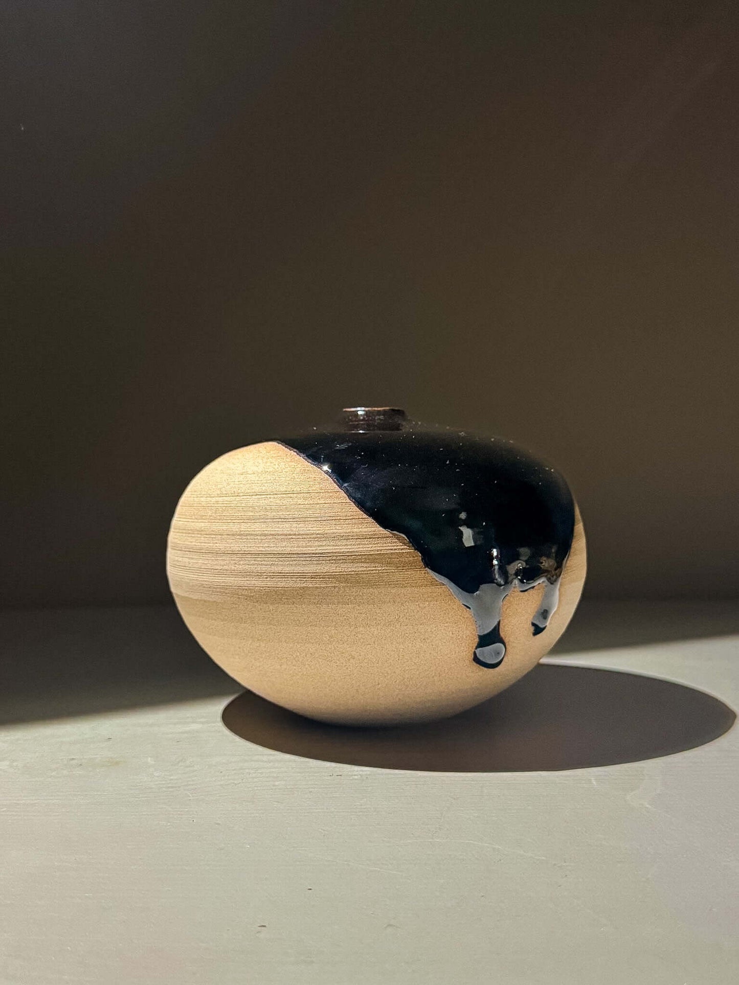 Orb Vase – Kuro #01 - Japanese handmade ceramic orb vase featuring natural glaze movement.