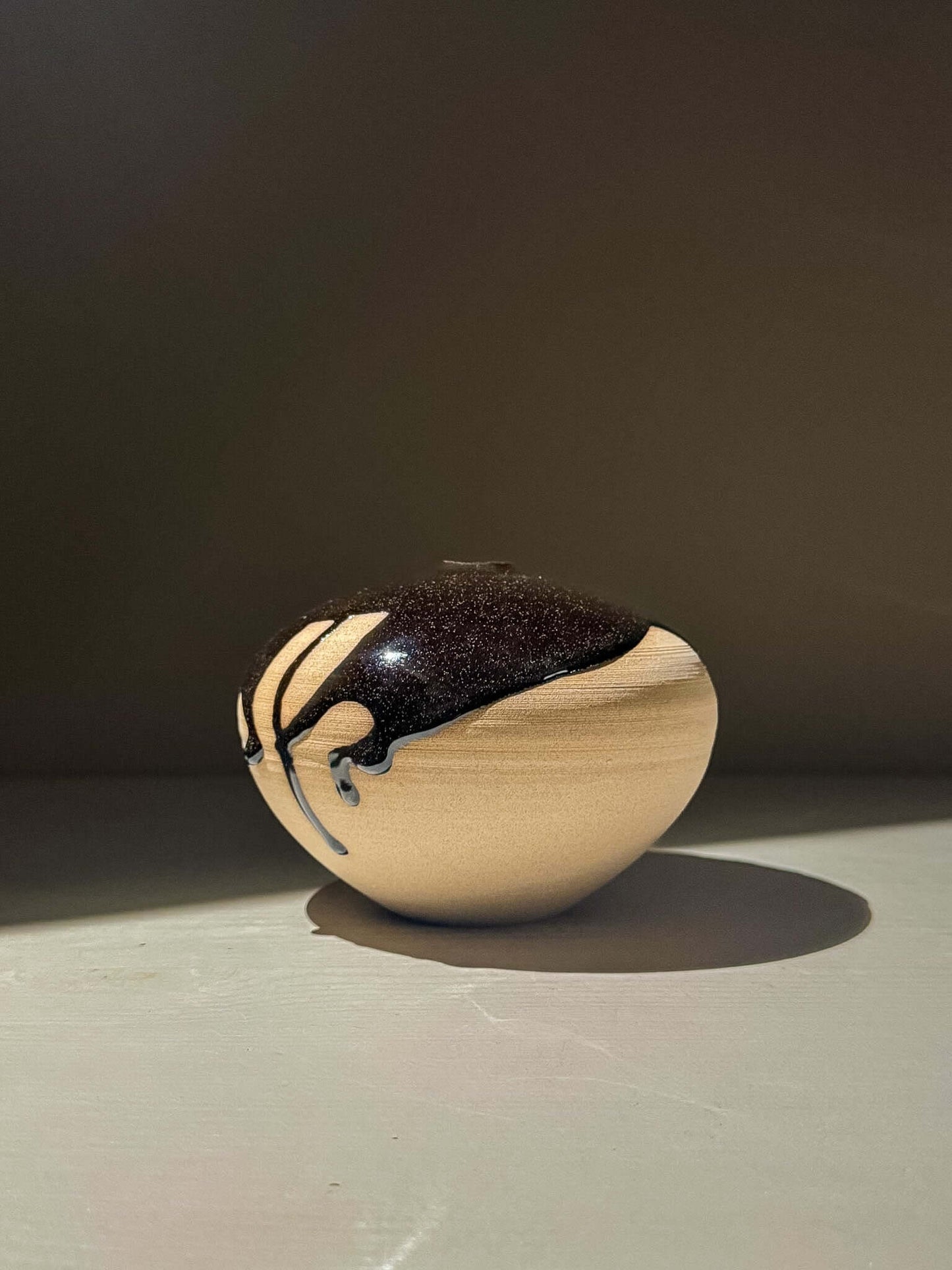 Orb Vase – Kuro #02 - Japanese handmade ceramic orb vases with unique glaze patterns and soft spherical form.