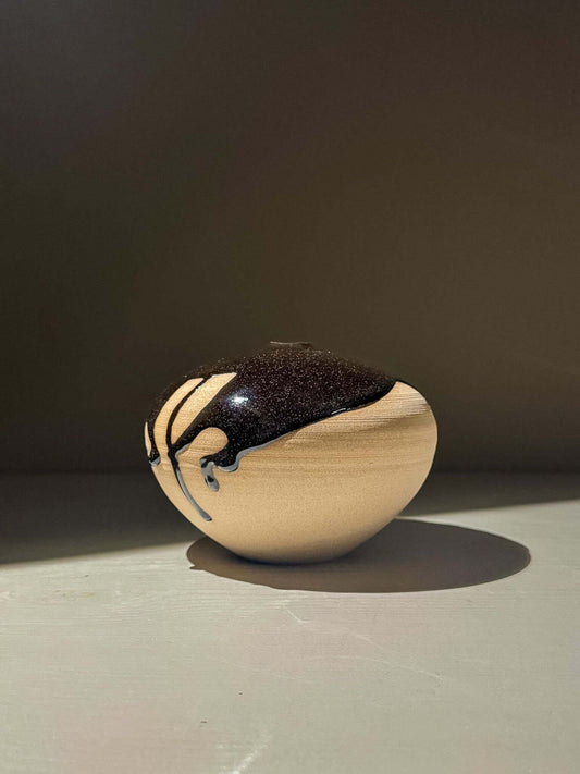 Orb Vase – Kuro #02 - Japanese handmade ceramic orb vases with unique glaze patterns and soft spherical form.