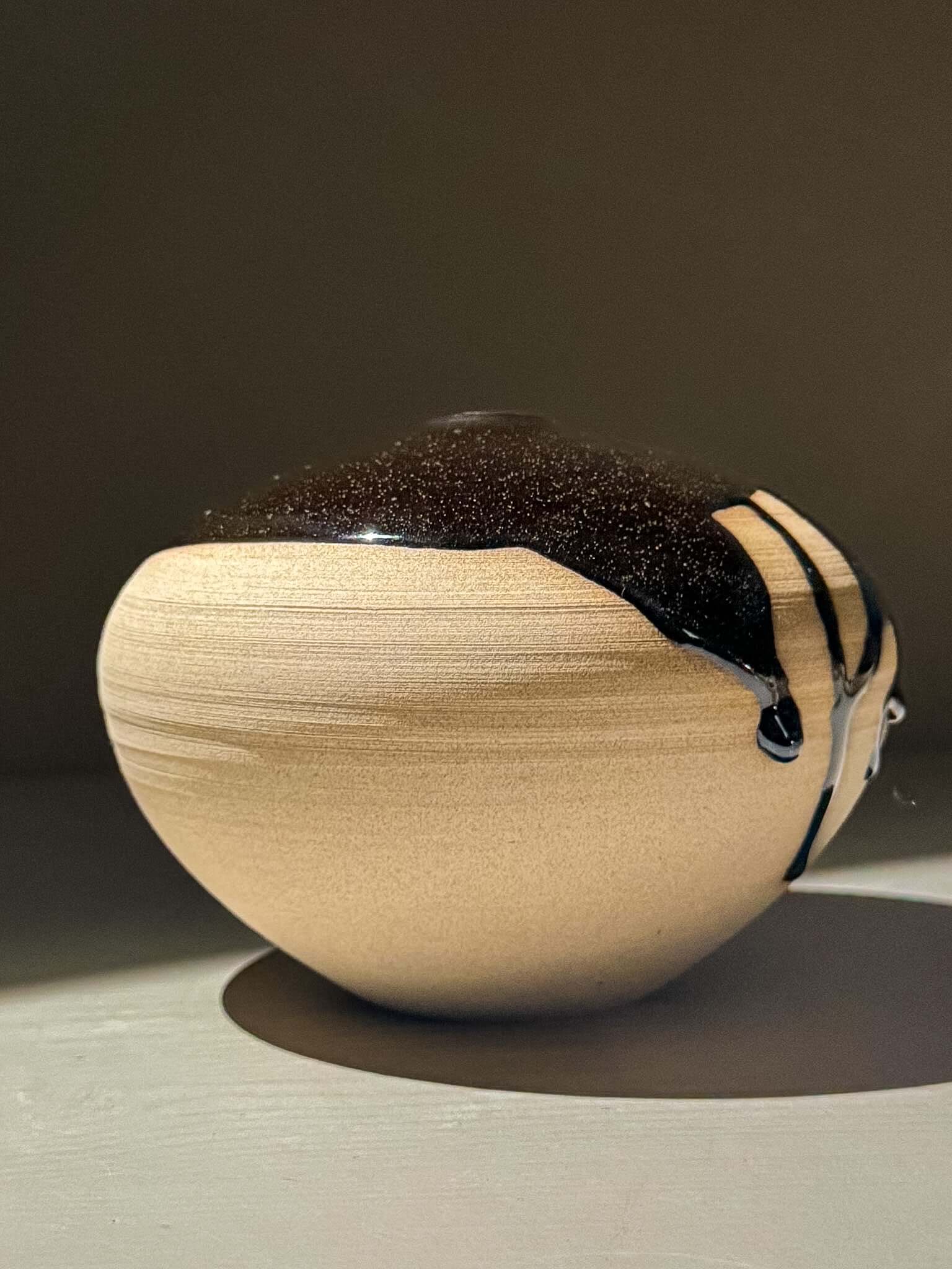 Orb Vase – Kuro #02 - Japanese handmade ceramic orb vases with unique glaze patterns and soft spherical form.