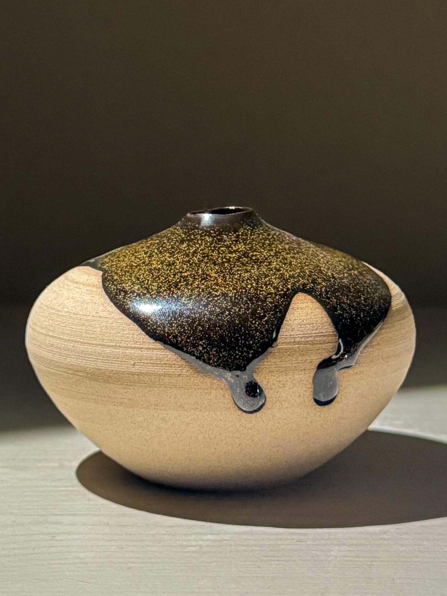 Orb Vase – Kuro #03, a unique japanese handmade ceramic orb vase with organic glaze patterns.