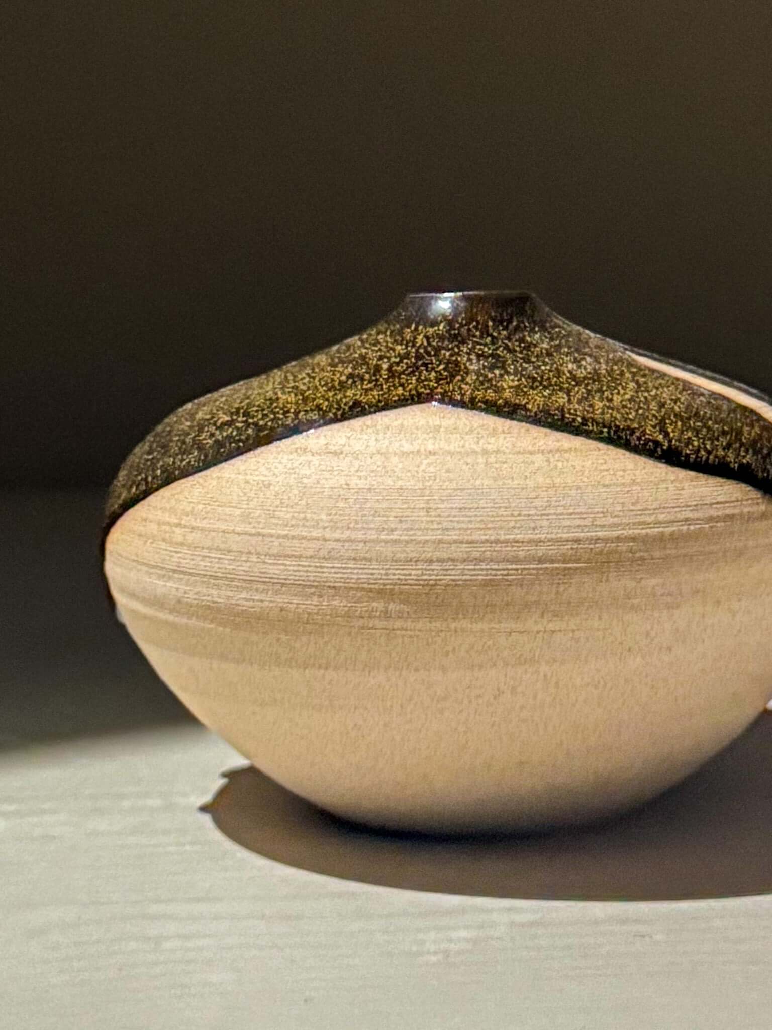 Orb Vase – Kuro #03, a unique japanese handmade ceramic orb vase with a soft spherical form and organic glaze patterns.