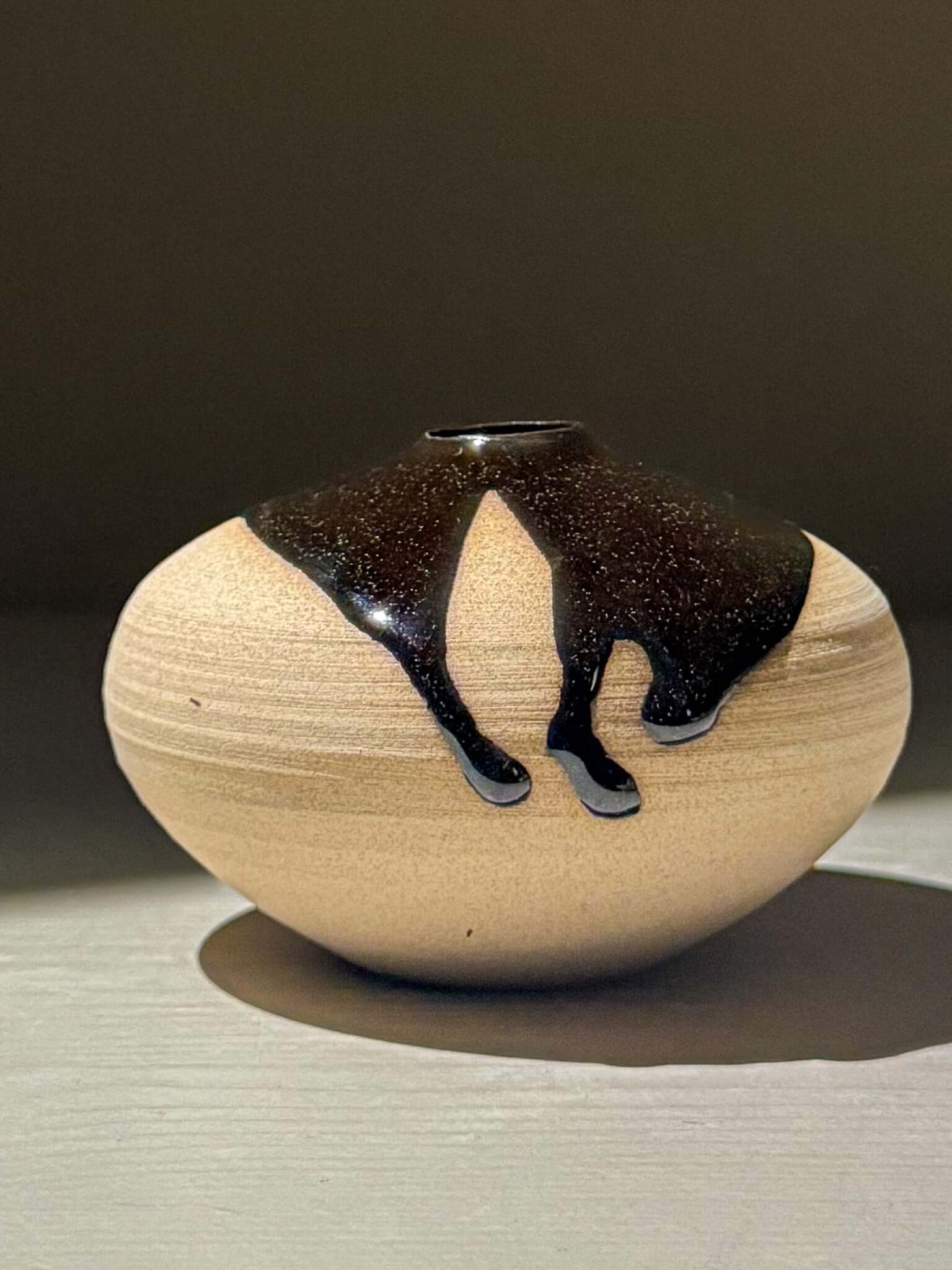 Orb Vase – Kuro #04, a unique japanese handmade ceramic orb vase with organic glaze patterns.