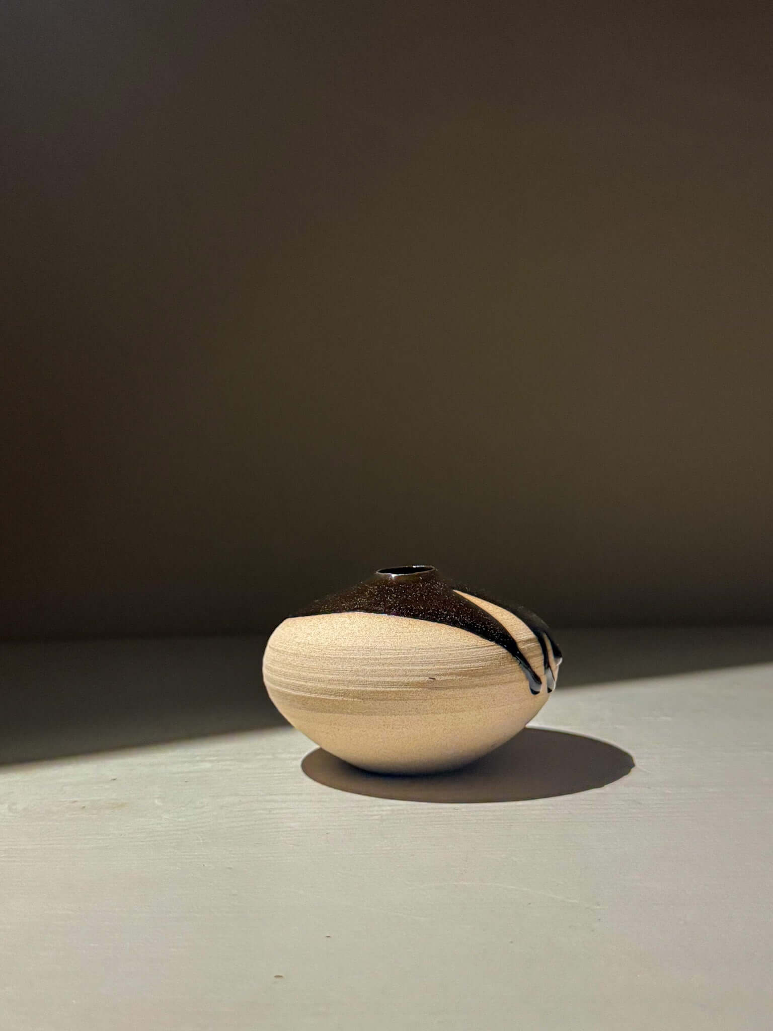 Orb Vase – Kuro #04, a unique japanese handmade ceramic orb vase with organic patterns and a calming spherical form.