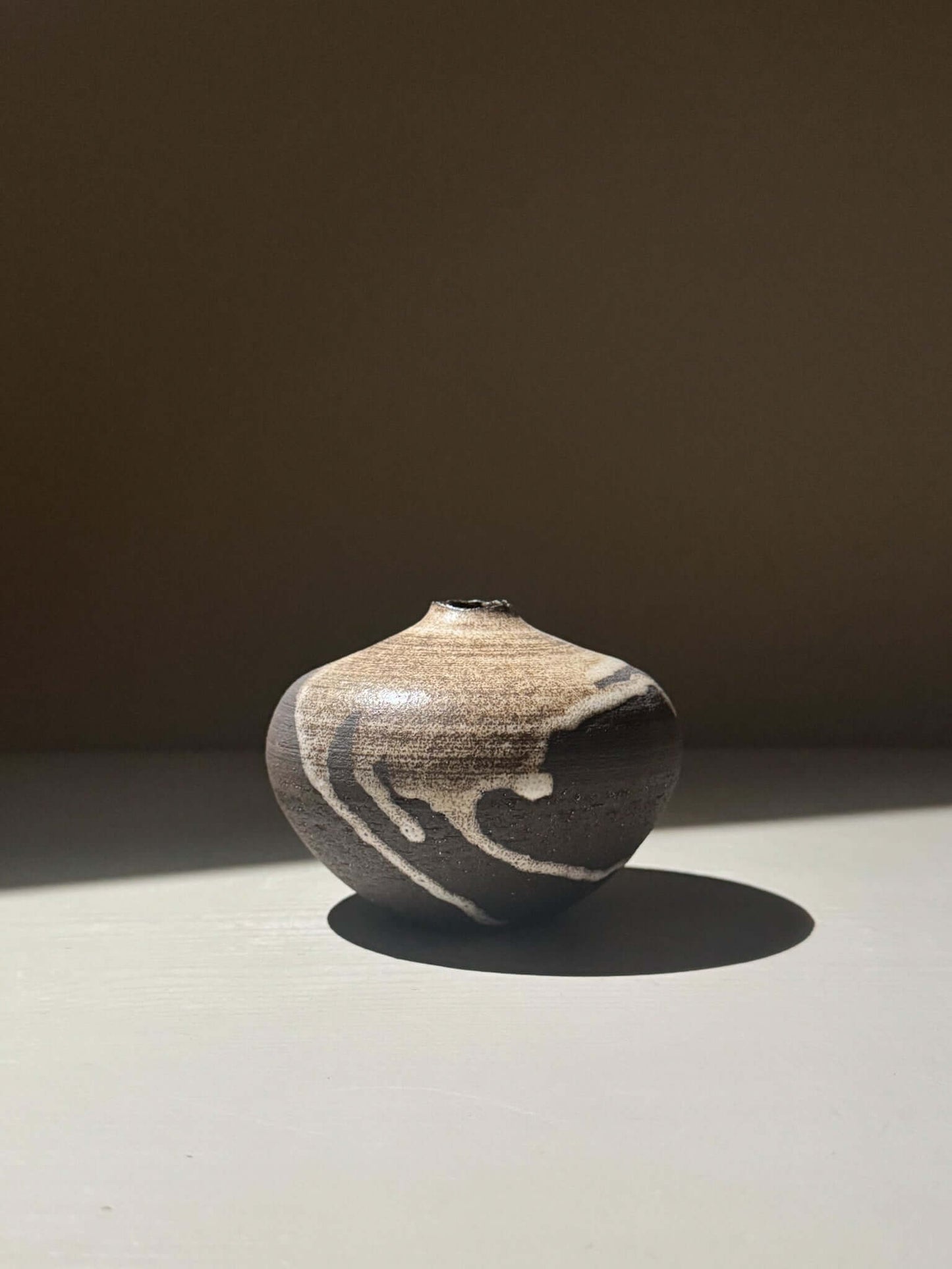 Orb Vase – Matt Clear with organic patterns and soft spherical form, showcasing unique glaze movement.