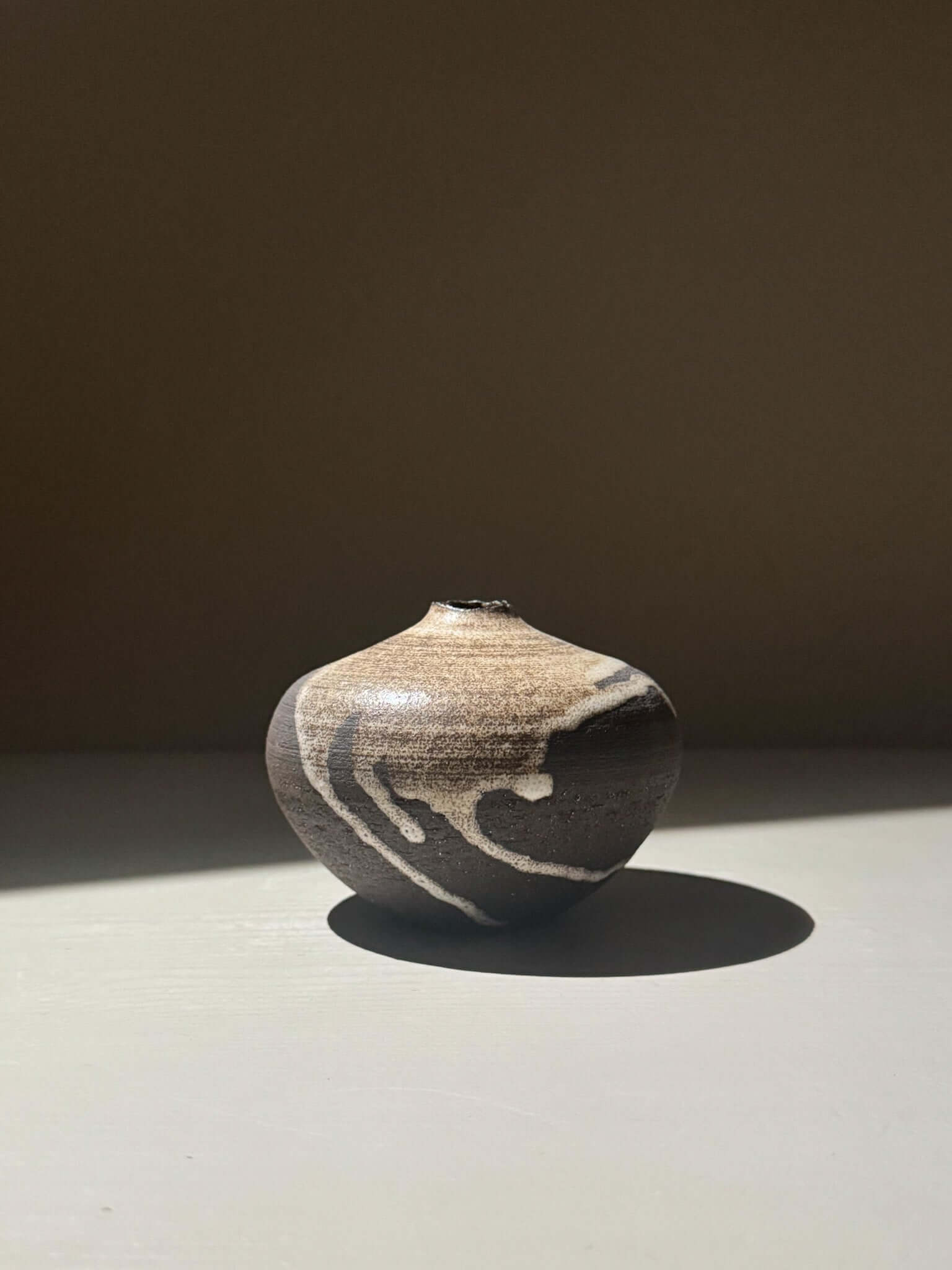 Orb Vase – Matt Clear with organic patterns and soft spherical form, showcasing unique glaze movement.
