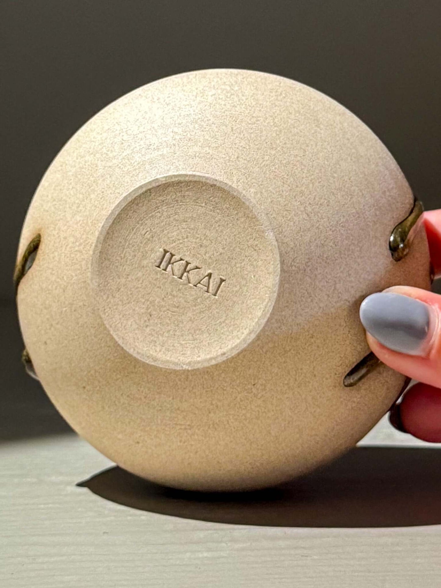 Handmade ceramics Orb Vase – Tenmoku #12 with IKAI branding on the base, showcasing a smooth, rounded shape.