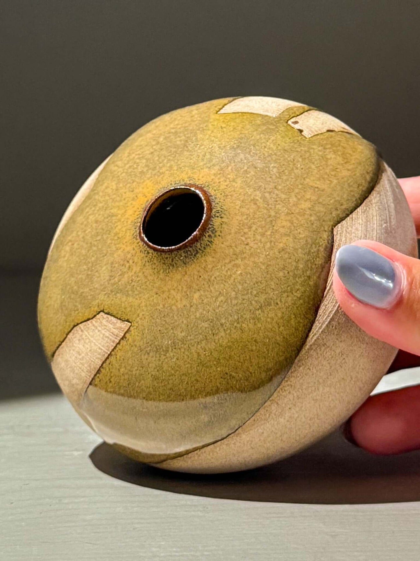 Handmade ceramics Orb Vase – Tenmoku #12 displaying unique glaze patterns and organic shape.