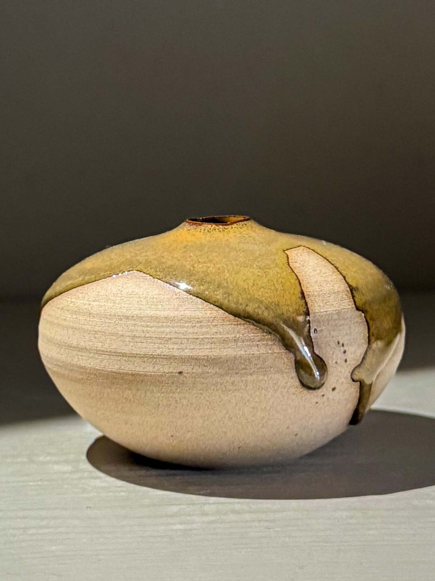Orb Vase – Tenmoku #12, handmade ceramics with unique glaze patterns and soft spherical shape.