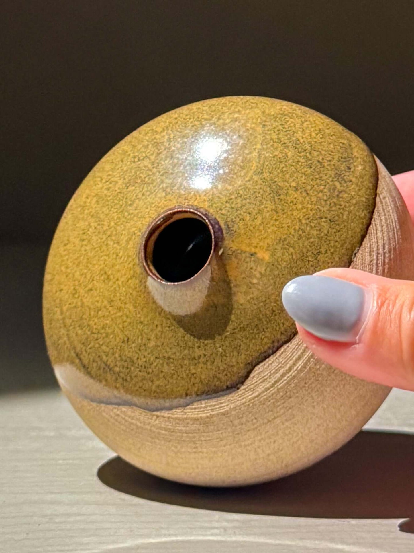 Orb Vase – Tenmoku #16 showcasing handmade ceramics with unique glaze patterns and a calm spherical form.