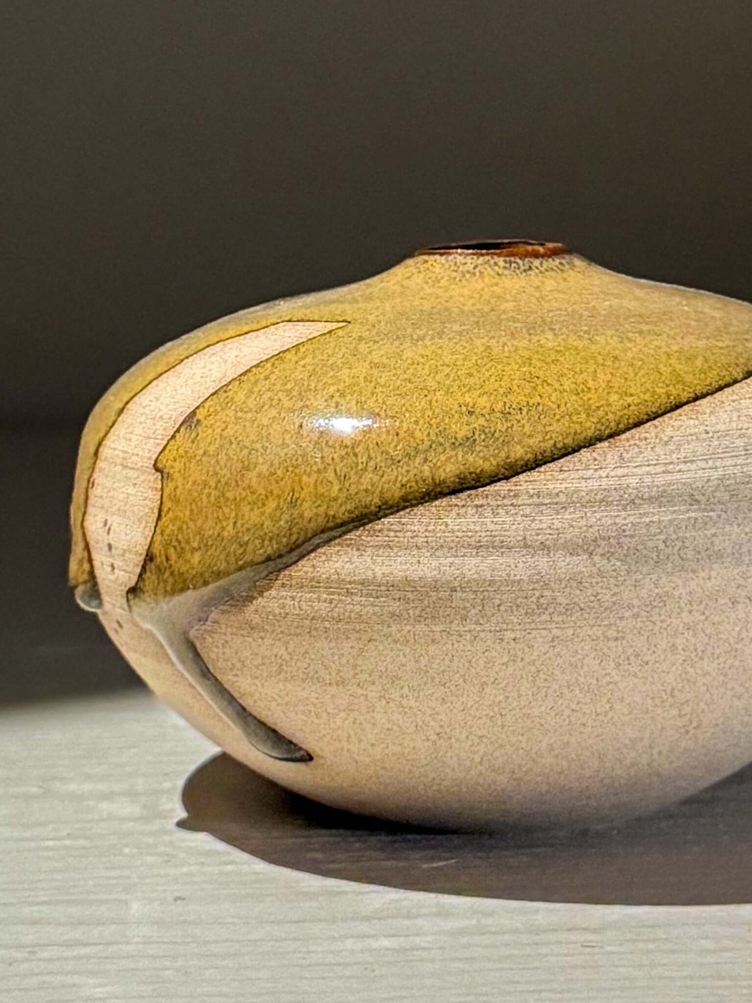 Orb Vase – Tenmoku #12, handmade ceramics with unique glaze patterns and rounded, sculptural form.