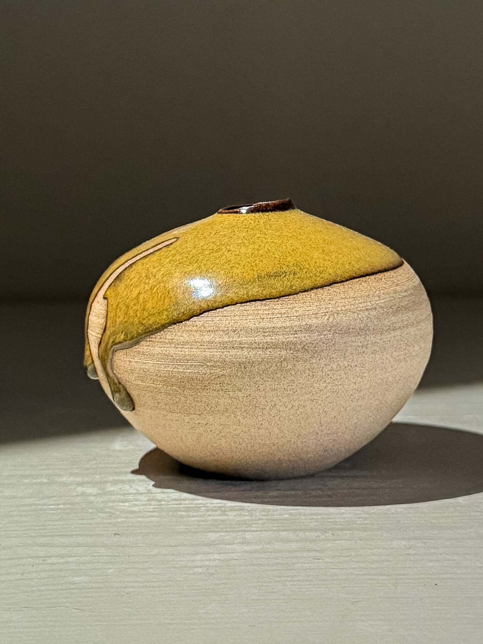 Orb Vase – Tenmoku #15 handmade ceramics with a unique glaze and organic patterns, showcasing a calm sculptural presence.