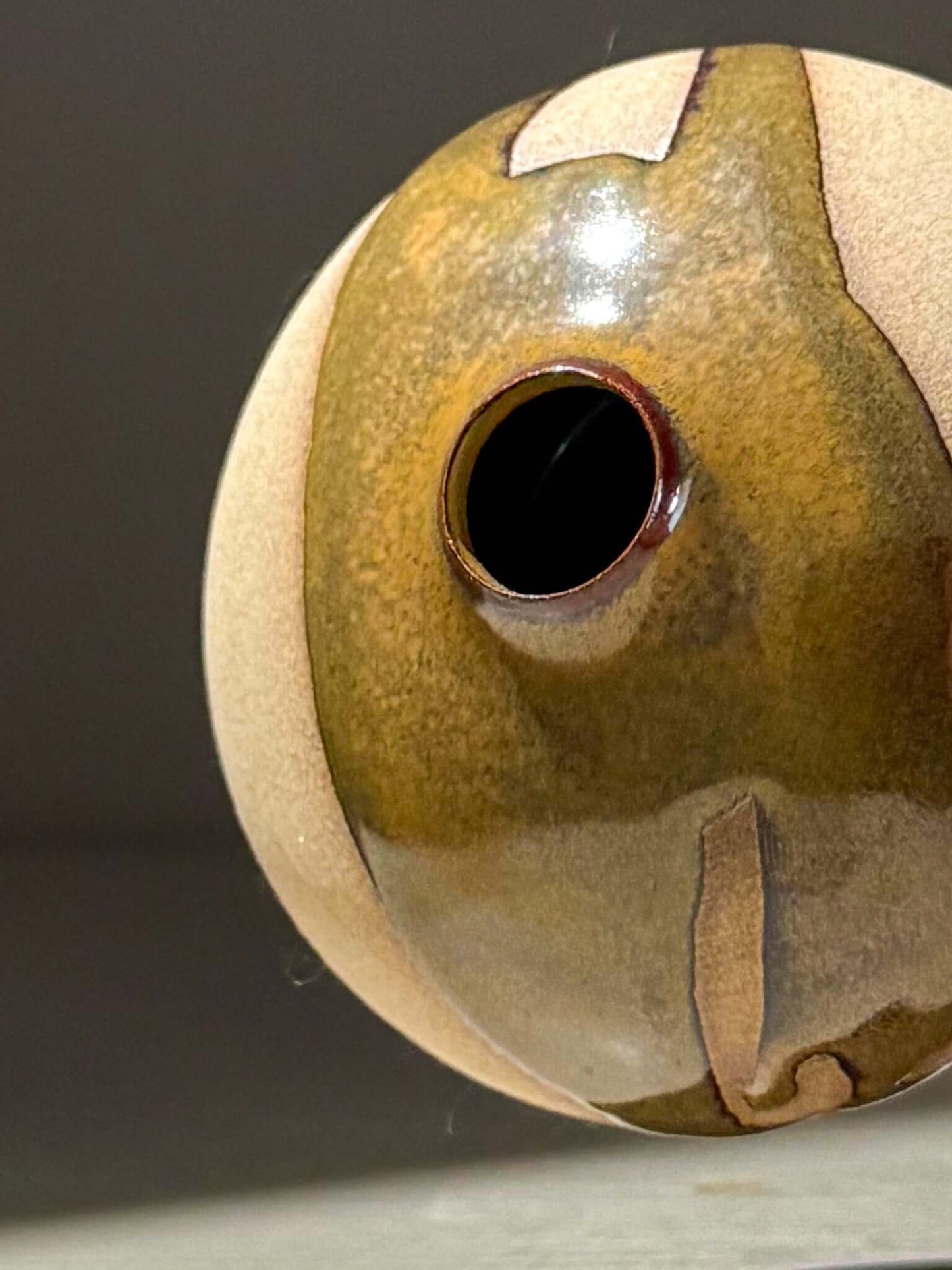 Close-up of Orb Vase – Tenmoku #13, showcasing its unique glaze and handmade ceramics craftsmanship.
