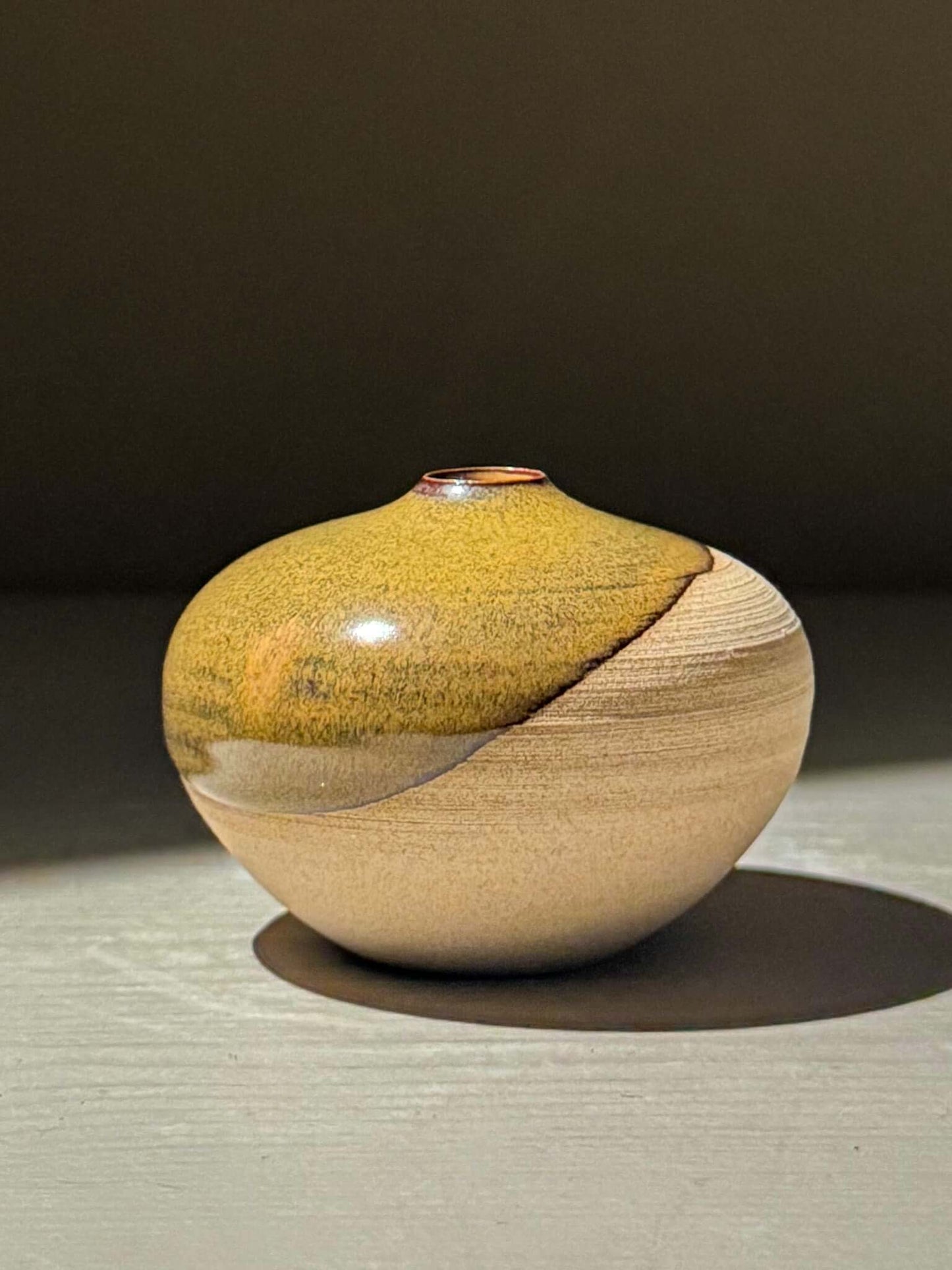 Orb Vase – Tenmoku #16 handmade ceramics with a unique glaze and rounded shape, showcasing gentle organic patterns.