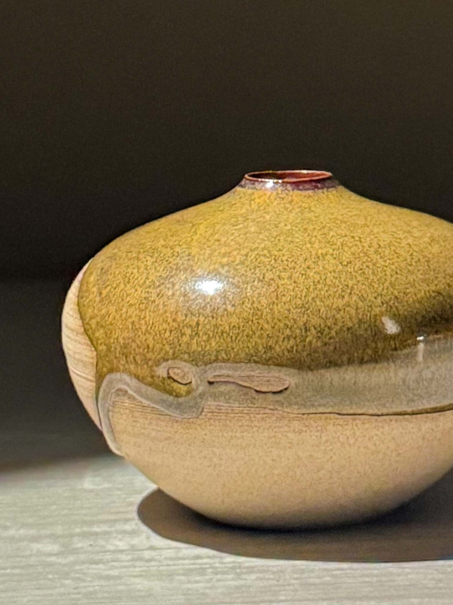 Orb Vase – Tenmoku #16, handmade ceramics with unique glaze patterns and soft rounded shape.