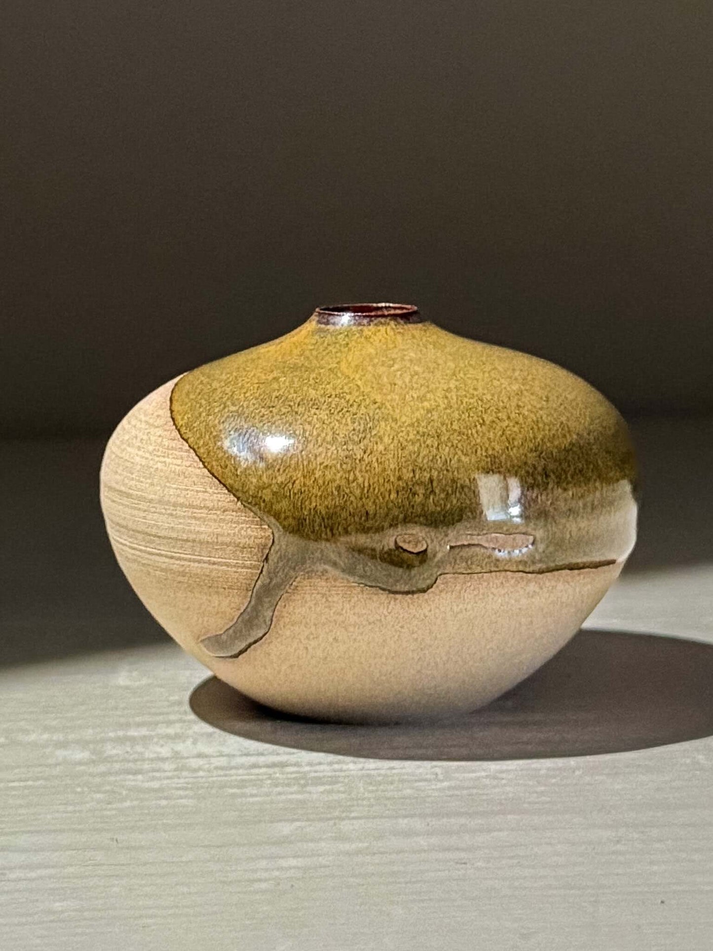 Orb Vase – Tenmoku #16 handmade ceramics with unique glaze patterns and soft spherical form.