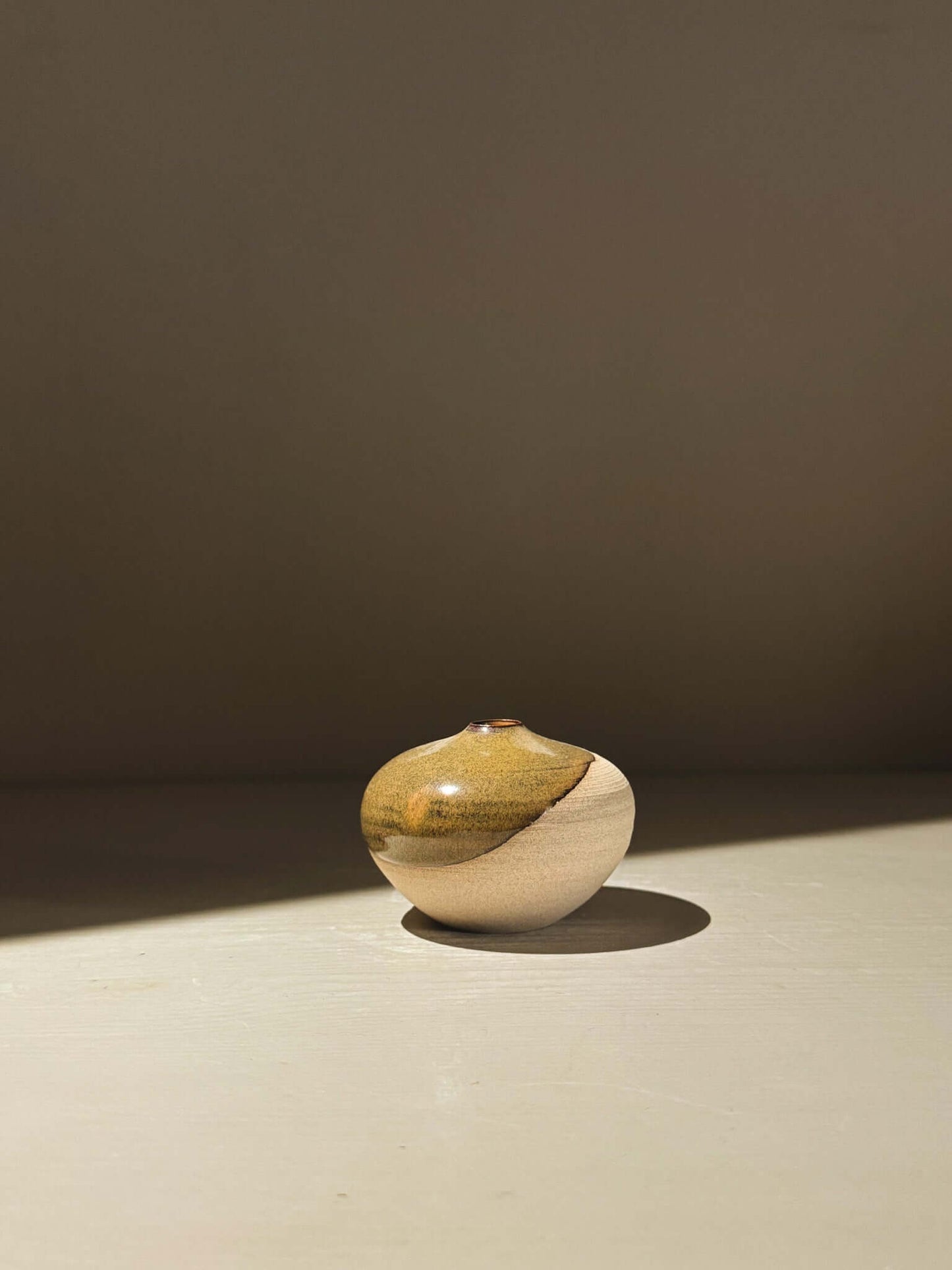 Orb Vase – Tenmoku #16, a handmade ceramic orb vase with a unique glaze finish.