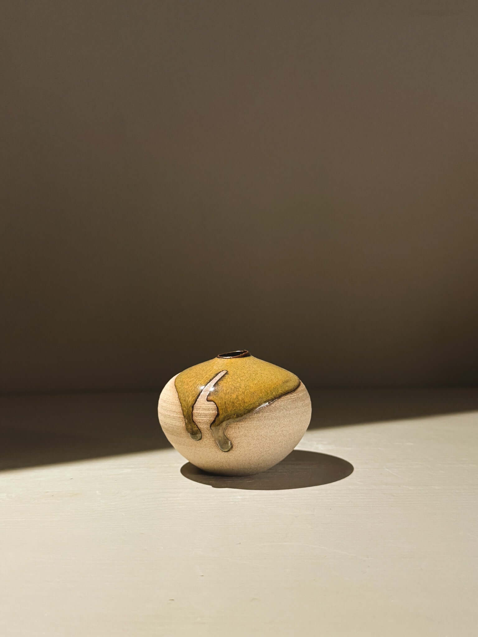 Handmade ceramics Orb Vase – Tenmoku #15 with unique glaze patterns and soft spherical form.