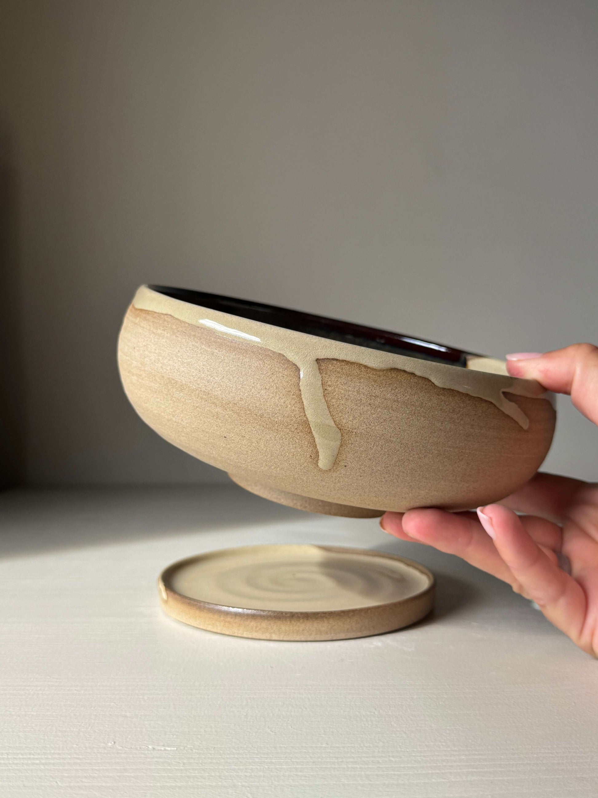 Handmade ceramic Rounded Berry Bowl - Inyo Series with drip plate, half-dipped in glossy tenmoku and clear glaze, for kitchen use.