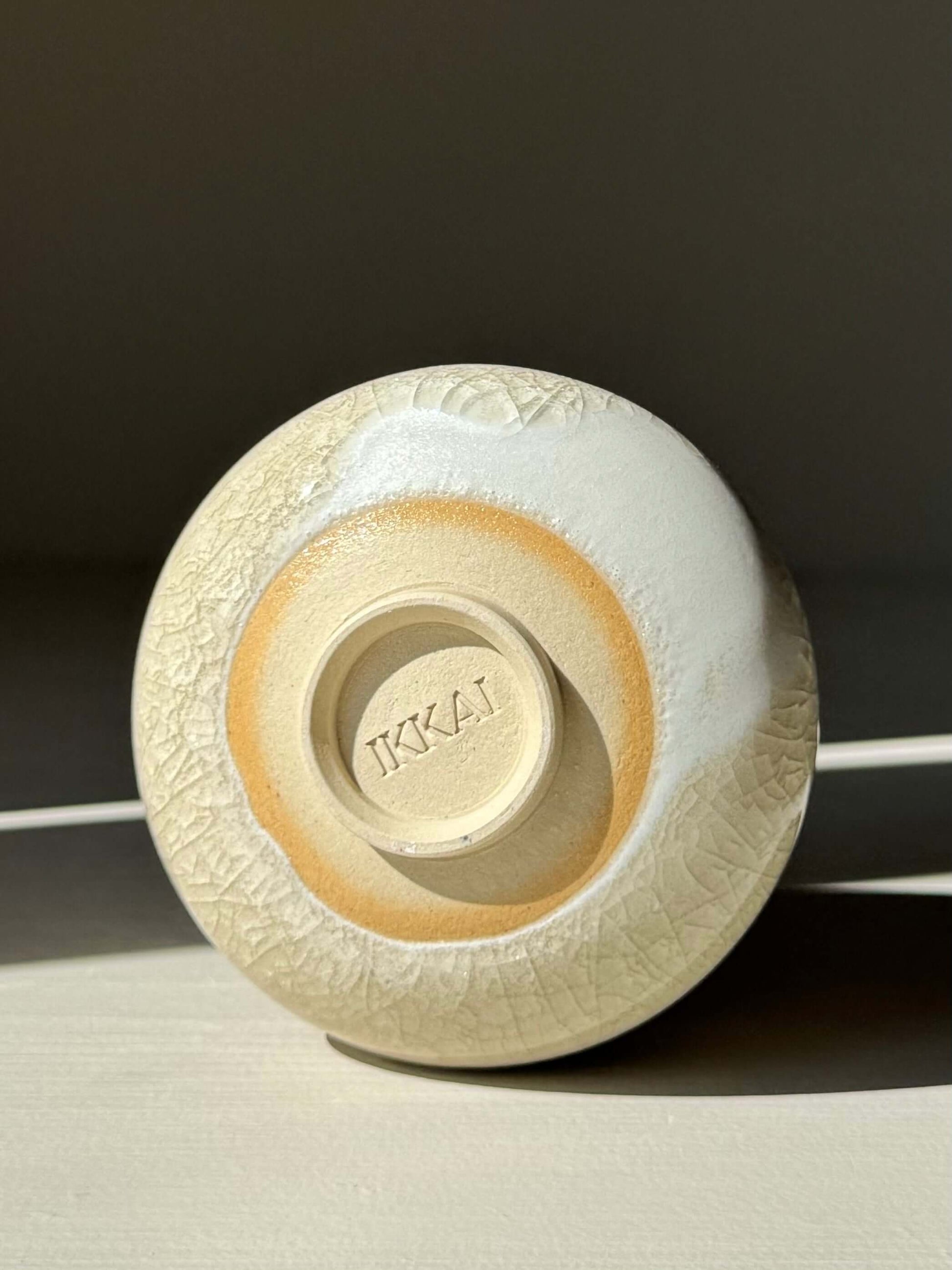 Yunomi Cup - Kannyū Series #03, handcrafted ceramic base showing IKKAI mark with crackle glaze detail.