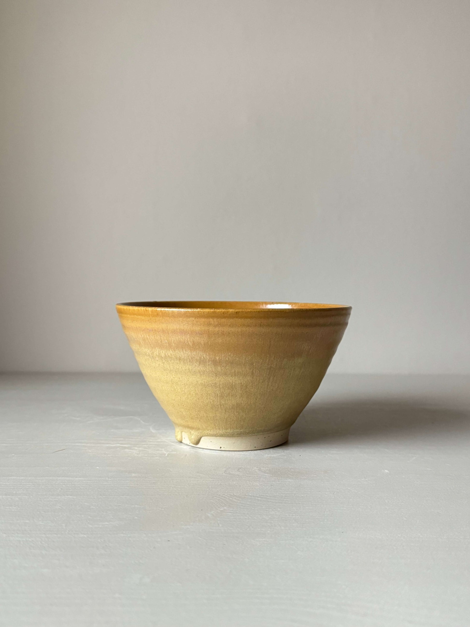 Golden yellow stoneware candlestick holder, wheel-thrown, handmade, 9cm height and 15cm diameter, unique ceramic piece.