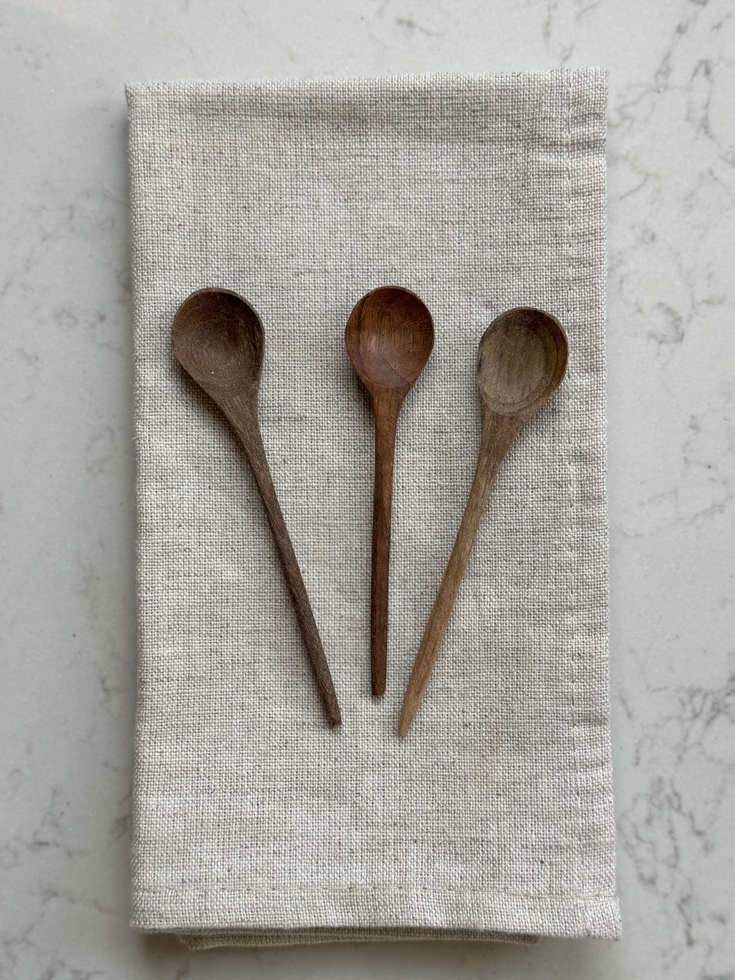 Walnut Wood Tea Spoons on linen cloth, hand-carved and handmade from natural walnut, perfect for coffee or tea stirring, Marrakech artisan craft.