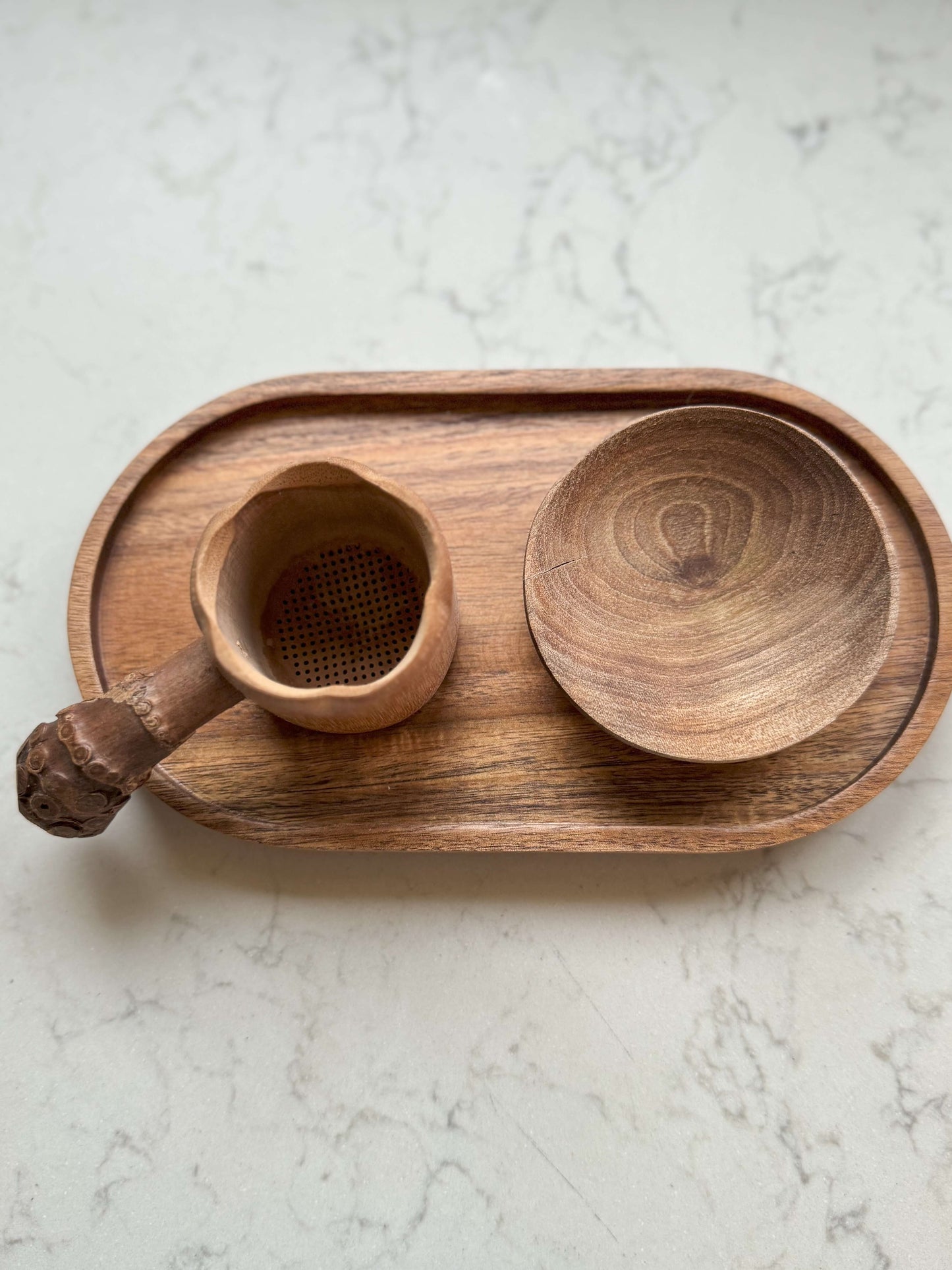 Bamboo Tea Strainer (Root Handle) with handmade ceramic look, displayed on a wooden tray.