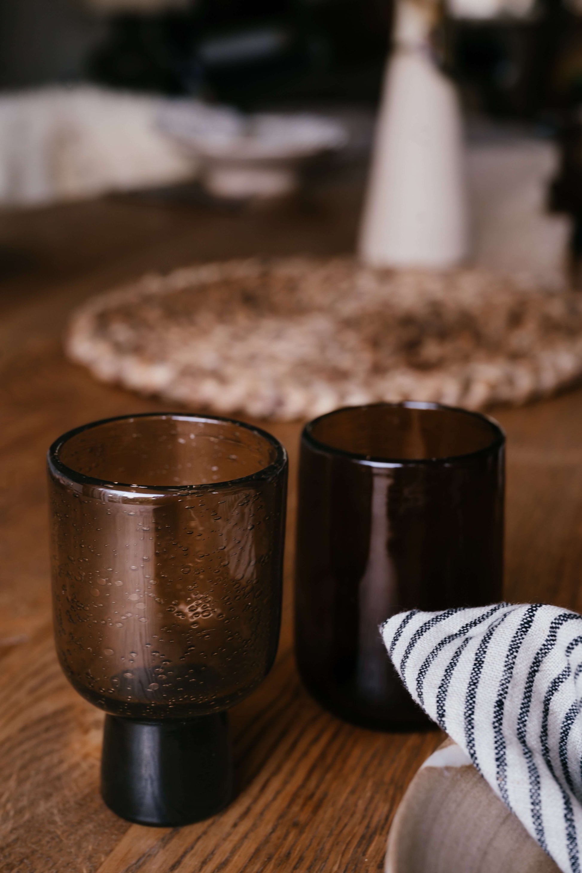 Brown Water Glass – Natural Tumbler, handmade ceramic brown tumblers with unique air bubbles on a wooden table setting.