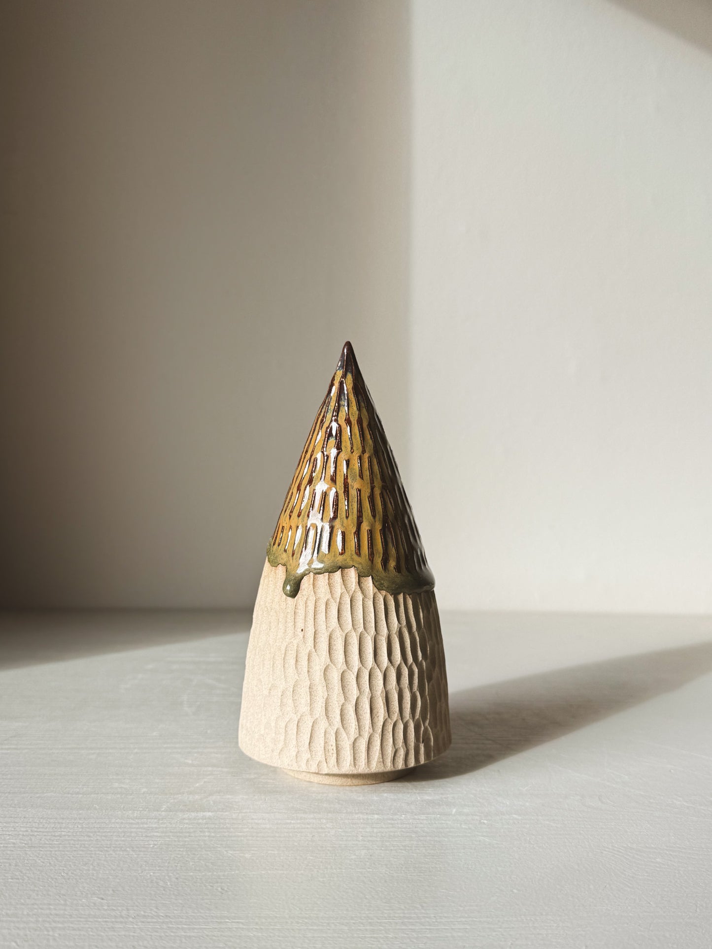 Carved Ceramic Tree – Inyo #01 with tenmoku glaze, showing carved textures and earthy tones in soft lighting.