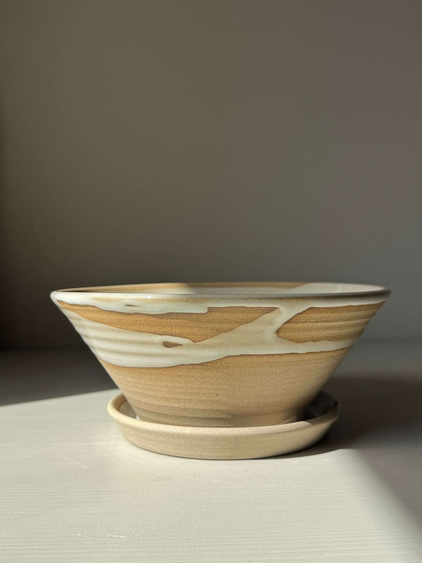 Handmade ceramic Berry Bowl - Yuki Series with drip plate, featuring soft white glaze over warm toffee clay in natural light.