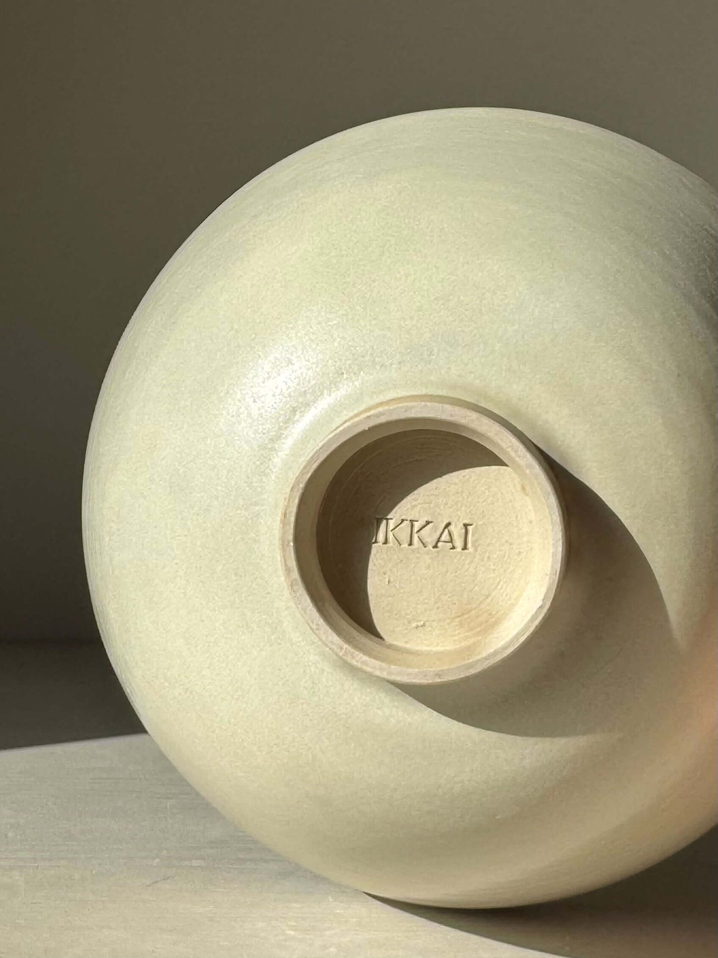 Close-up of handmade ceramic Bowl - Moonstone #01 showcasing moonstone glaze finish and studio mark at the base.