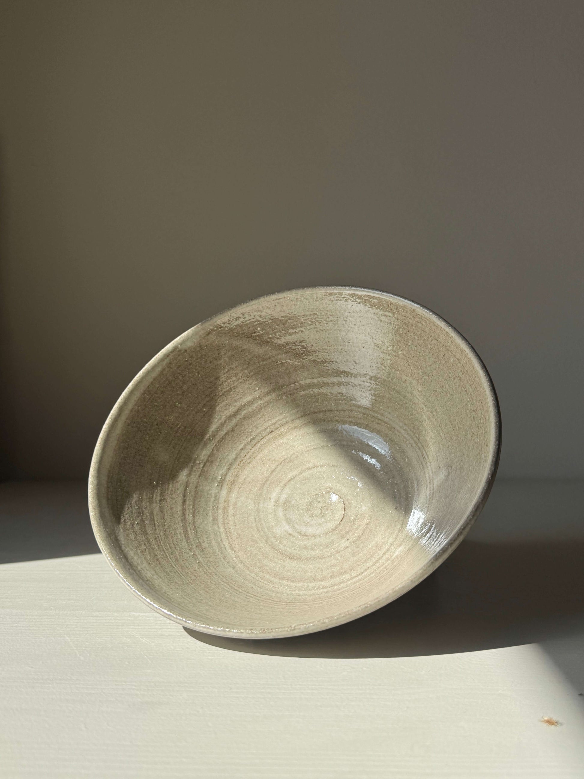 Handmade ceramic Bowl – Yuki Series Dark Clay with white glaze showcasing wheel-thrown texture in soft natural light.
