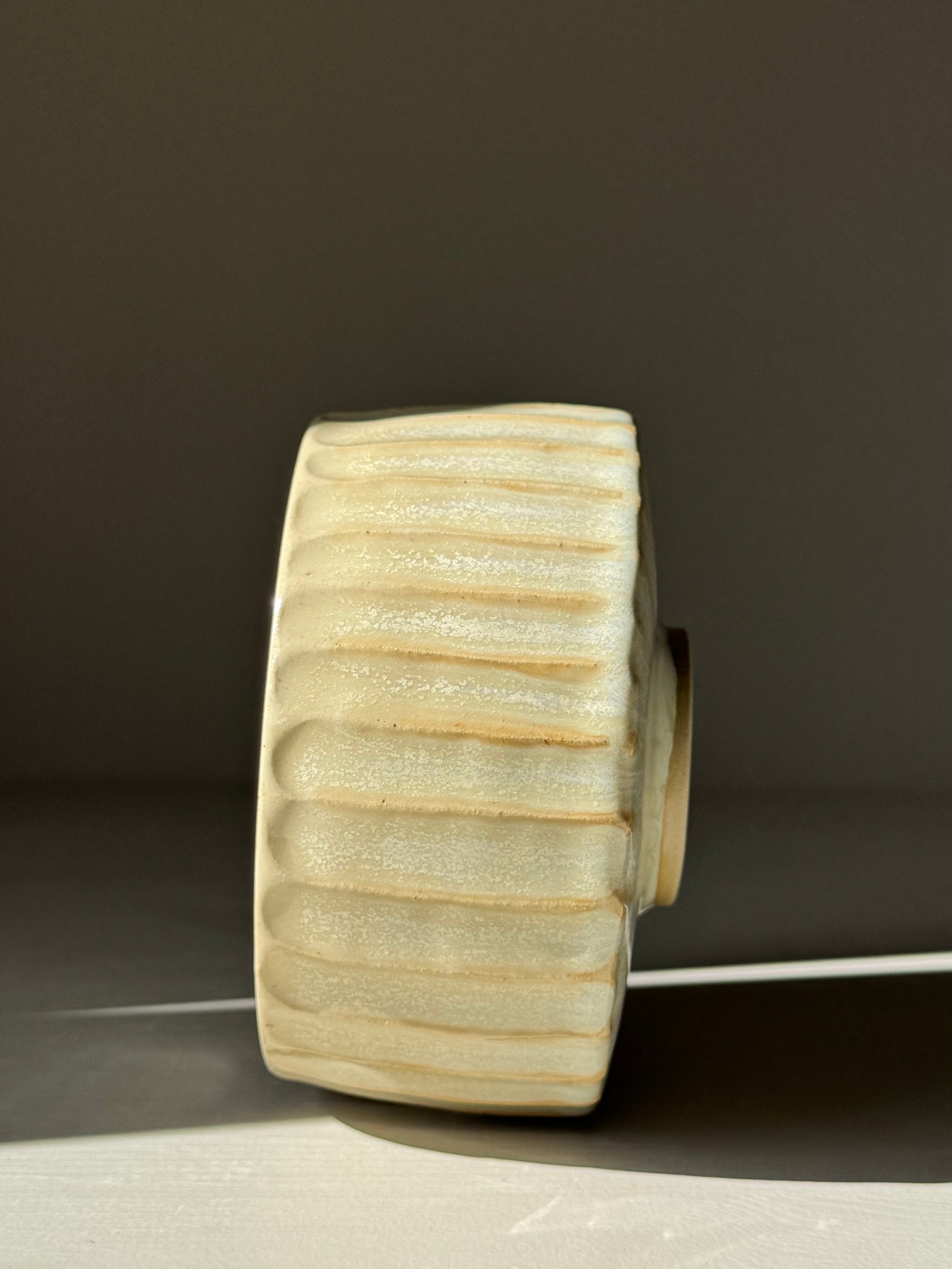 Carved Matcha Bowl – Moonstone Glaze #01, handmade ceramic with ridge texture and pale moonstone hue, side view.