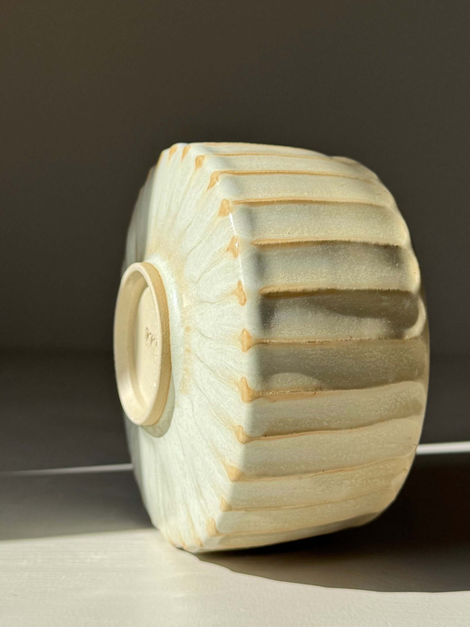 Handmade ceramic Carved Matcha Bowl – Moonstone Glaze #01 with textured ridges and pale glaze.