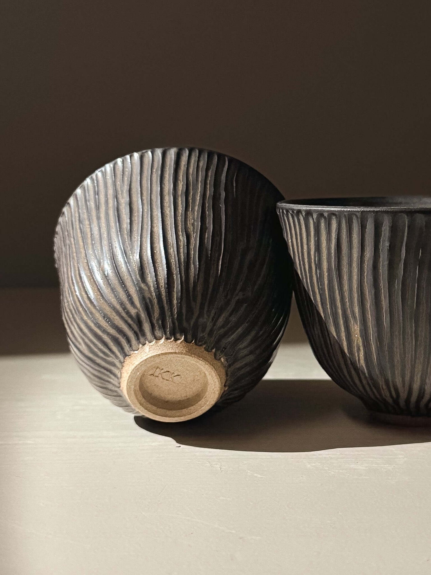 Carved Yunomi Cup - Black Truffle handmade ceramics with unique hand-carved texture showcasing pottery craftsmanship.