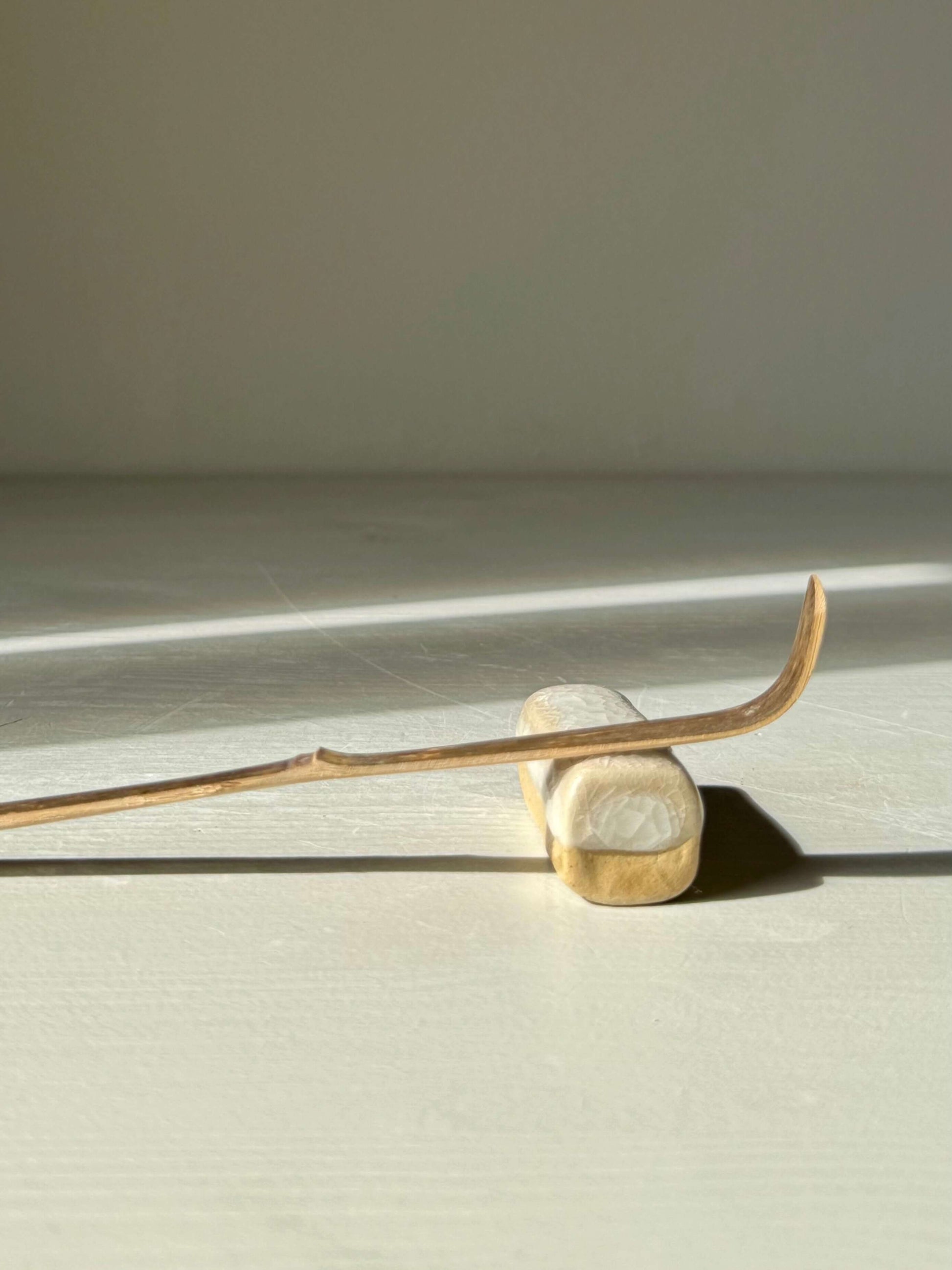 Handmade ceramic Chopstick/Spoon Rest – Kannyū with crackle glaze finish from Yuki Series placed on a table.