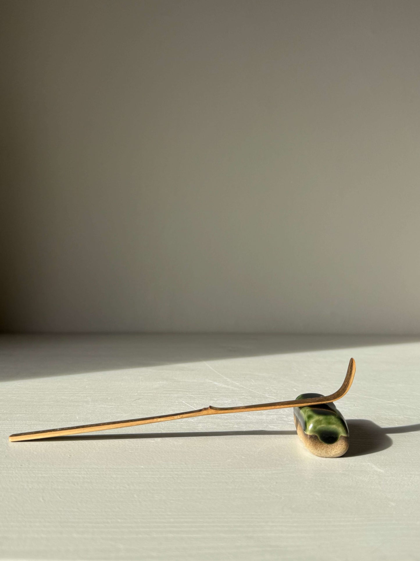 Handmade ceramic Chopstick/Spoon Rest – Mori with glossy green glaze, showcasing soft corners and simple form, perfect for dining.
