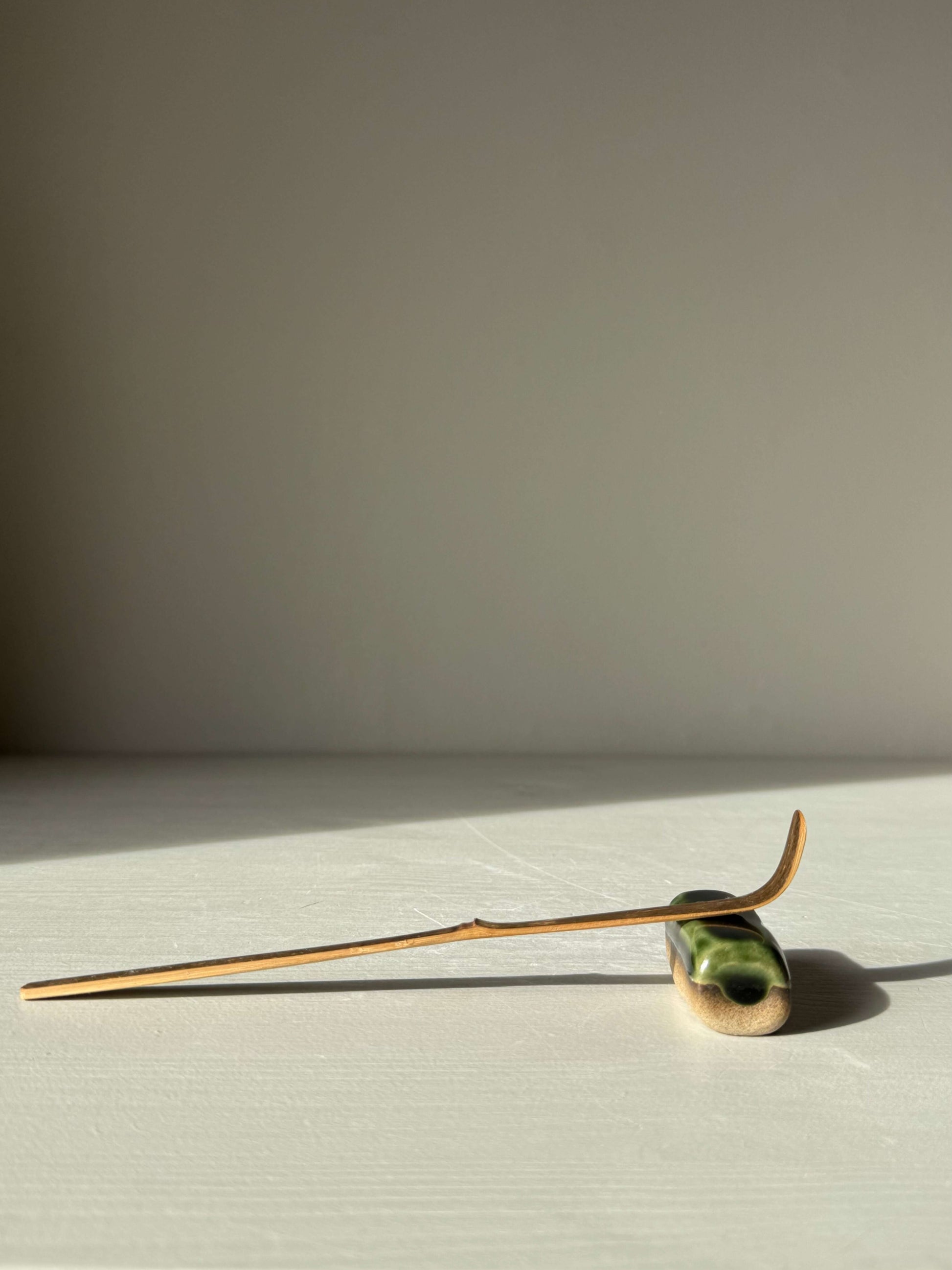 Handmade ceramic Chopstick/Spoon Rest – Mori with glossy green glaze, showcasing soft corners and simple form, perfect for dining.