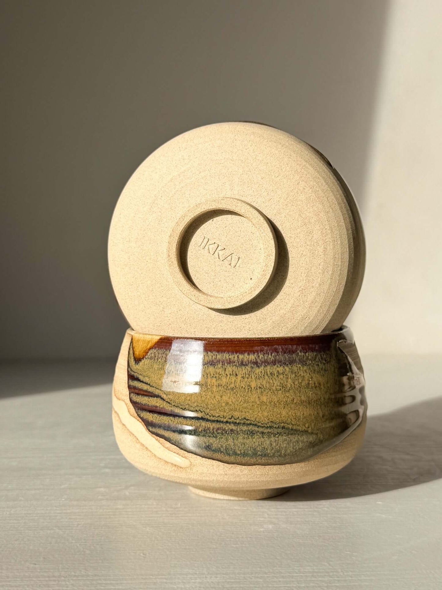 Handmade ceramic Coffee cups - Inyo with deep tenmoku and clear glaze, showcasing artistic craftsmanship in light and dark contrasts.