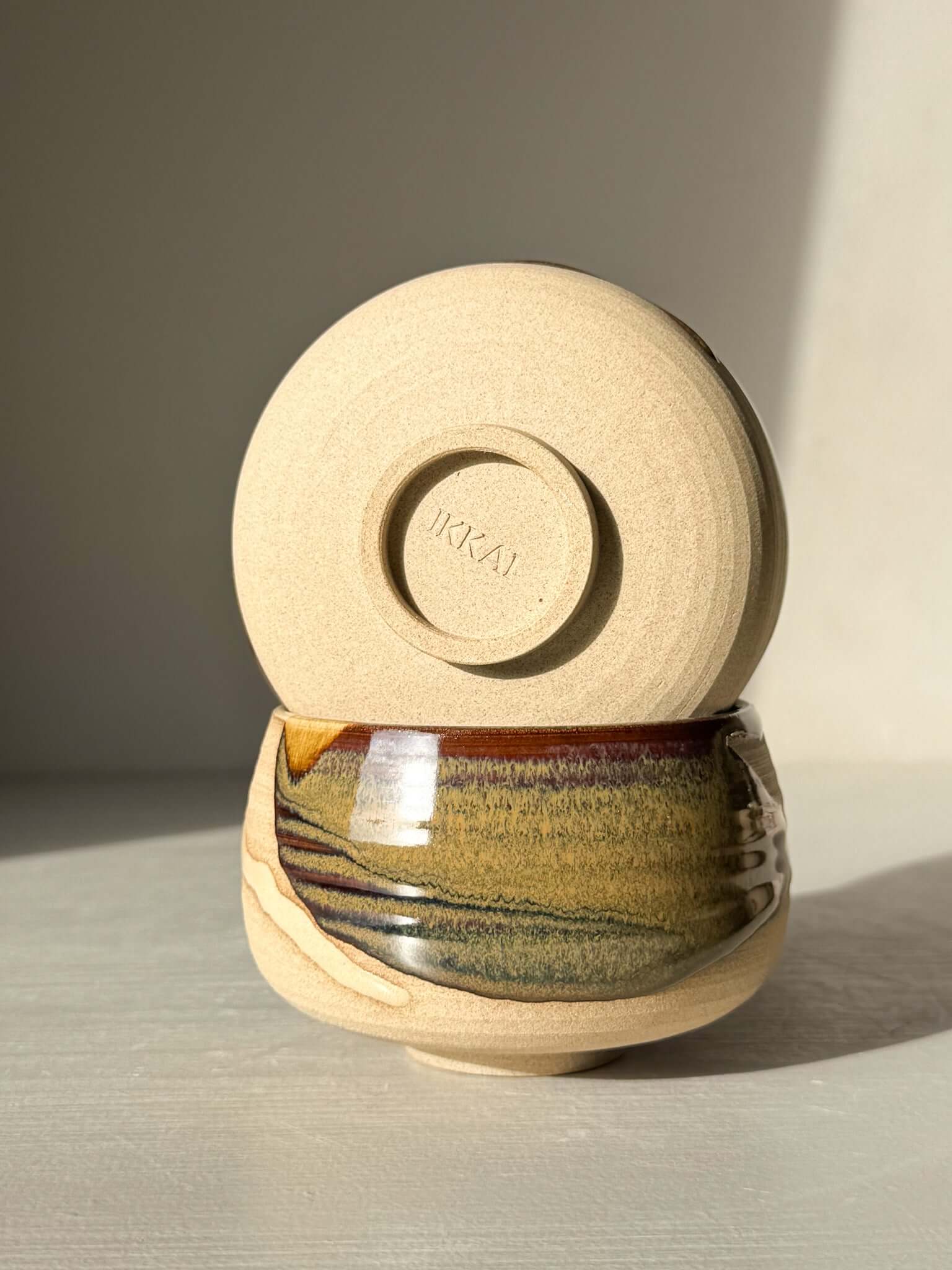 Handmade ceramic Coffee cups - Inyo with deep tenmoku and clear glaze, showcasing artistic craftsmanship in light and dark contrasts.