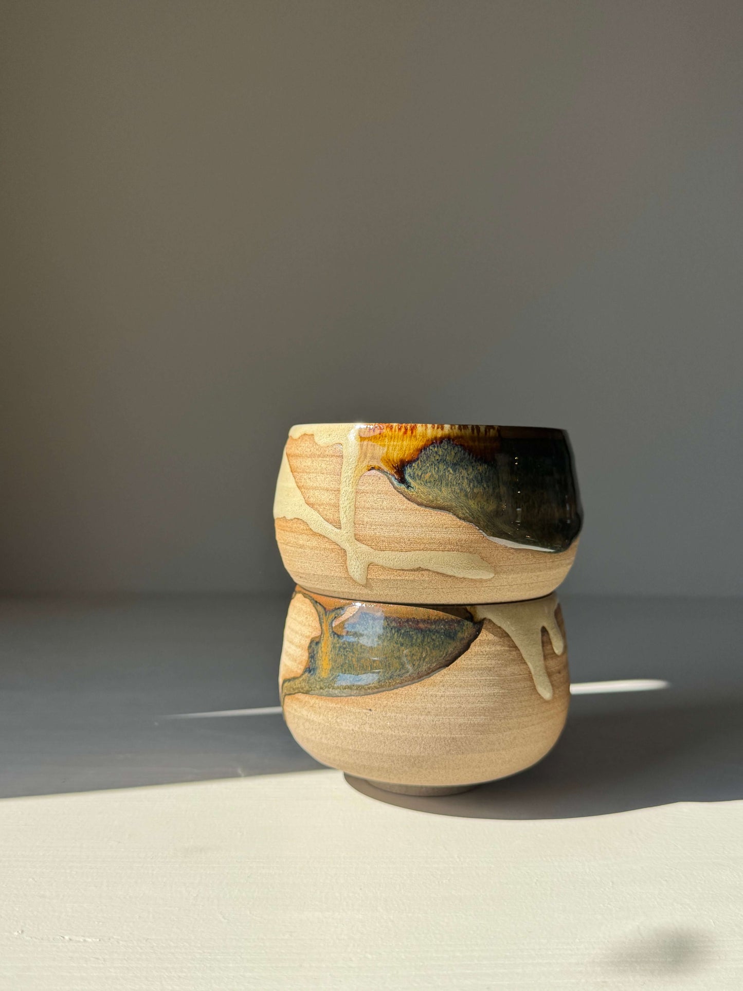 Handmade ceramic Coffee cups - Inyo Series with contrasting tenmoku and clear glazes, showcasing natural flowing patterns.