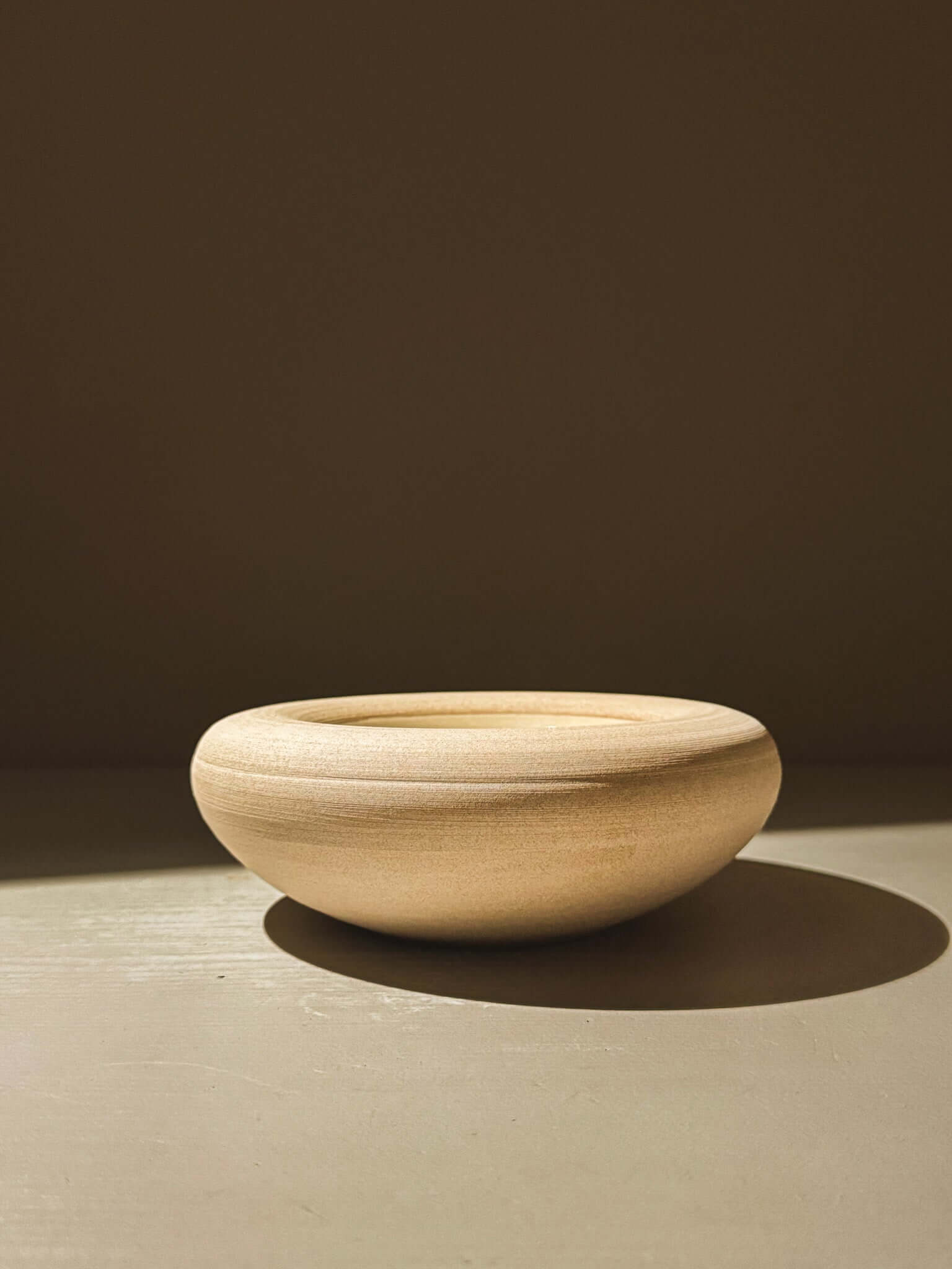 Elegant handcrafted double-walled ceramic bowl from Inyo Series, showcasing a warm toffee-toned clay with unique glazes inside.