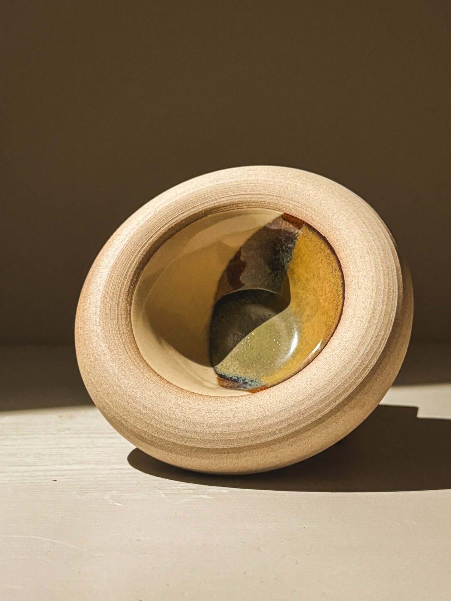 Elegant handmade stoneware bowl from Inyo Series, featuring a double-walled design with tenmoku glazes in deep browns and blues.