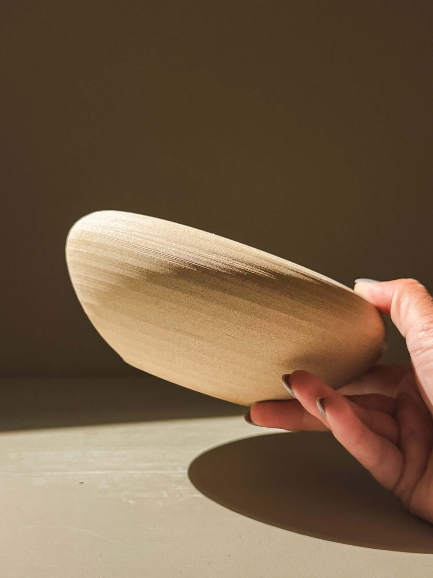 Handmade double-walled stoneware bowl from Inyo Series with toffee-toned clay and flowing lines, showcasing artisanal craftsmanship.