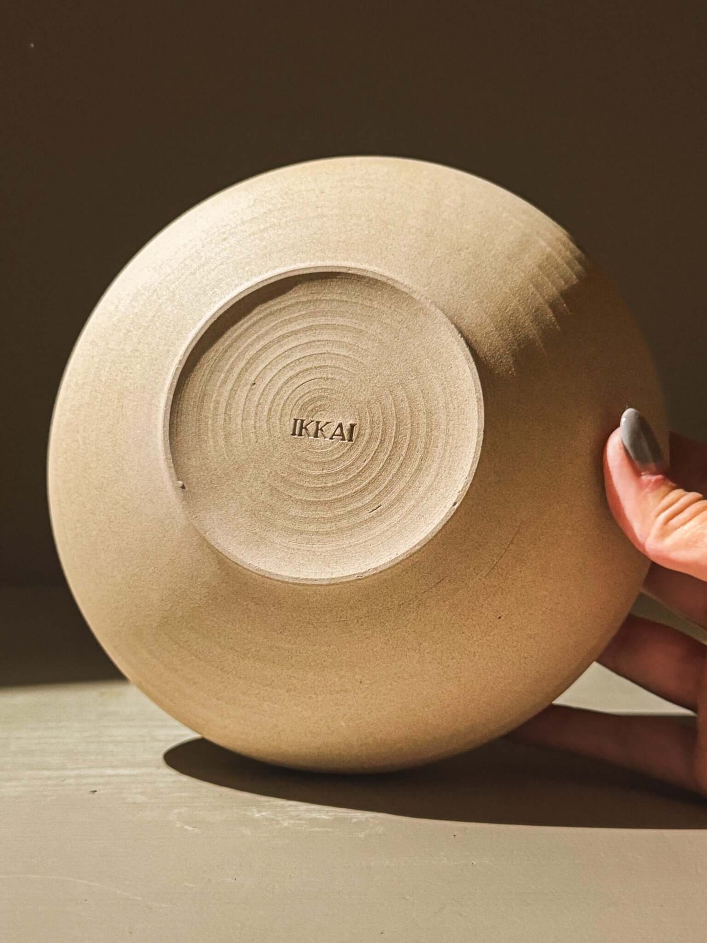Handcrafted double-walled ceramic bowl from Inyo Series in warm toffee clay with maker's mark on the bottom.