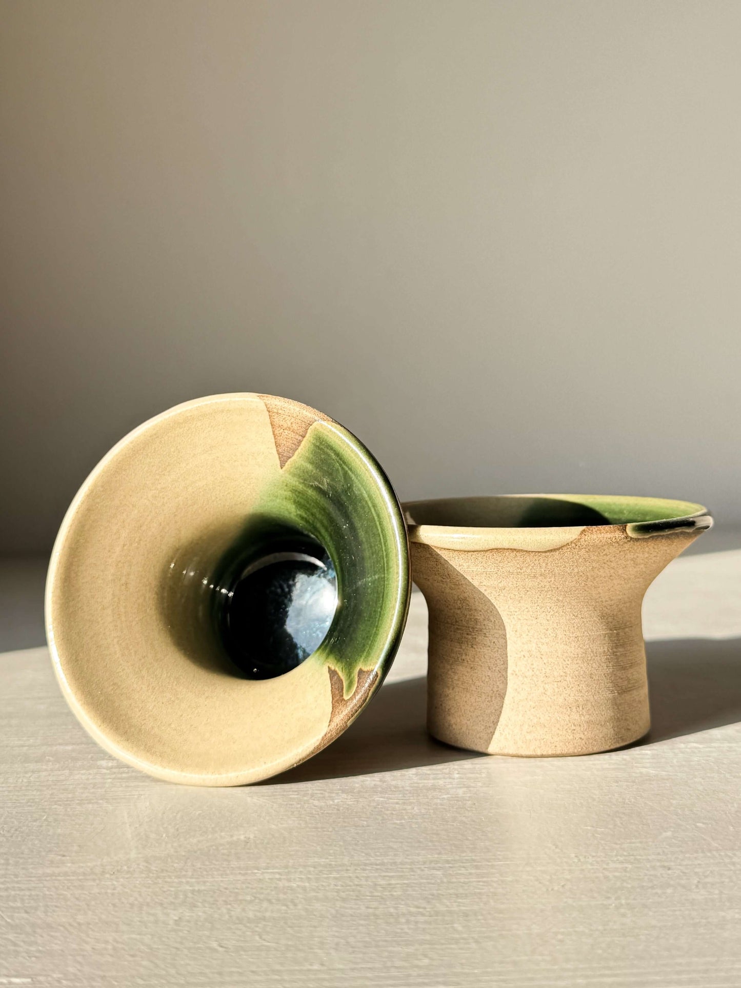 Handmade ceramic Egg Cup - Mori with soft green glaze and wide flared rim, showcasing the charming earthy design on stoneware.