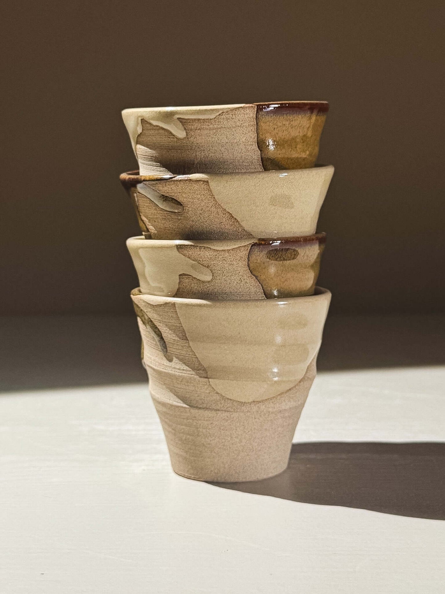 Espresso Cup - Inyo #01 stack of handmade ceramic cups featuring glossy tenmoku glaze and warm toffee tones.