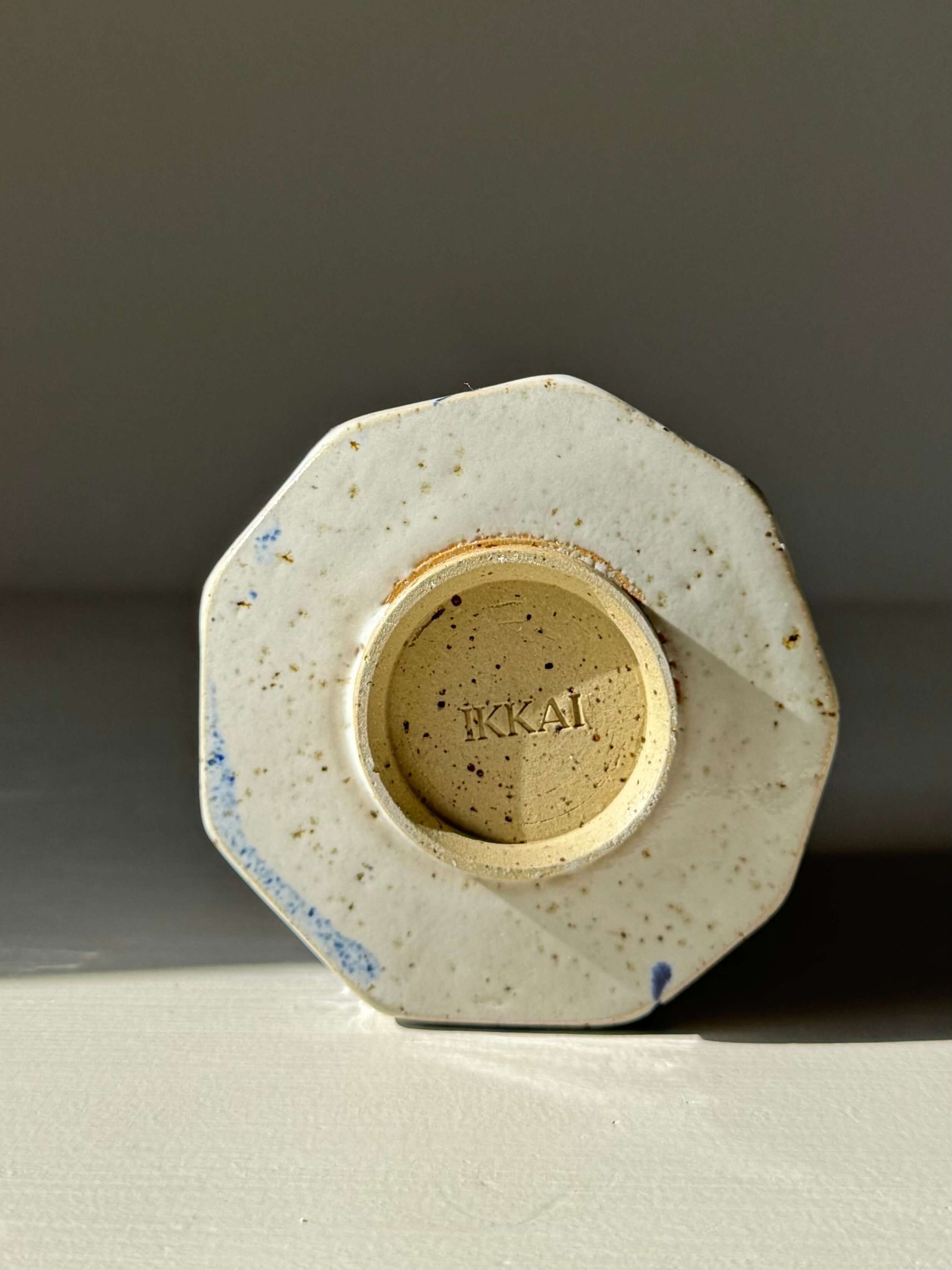 Base of handmade ceramic Faceted Cup – Cobalt Blue & Glossy White #01, showing the unique carved and glazed design.
