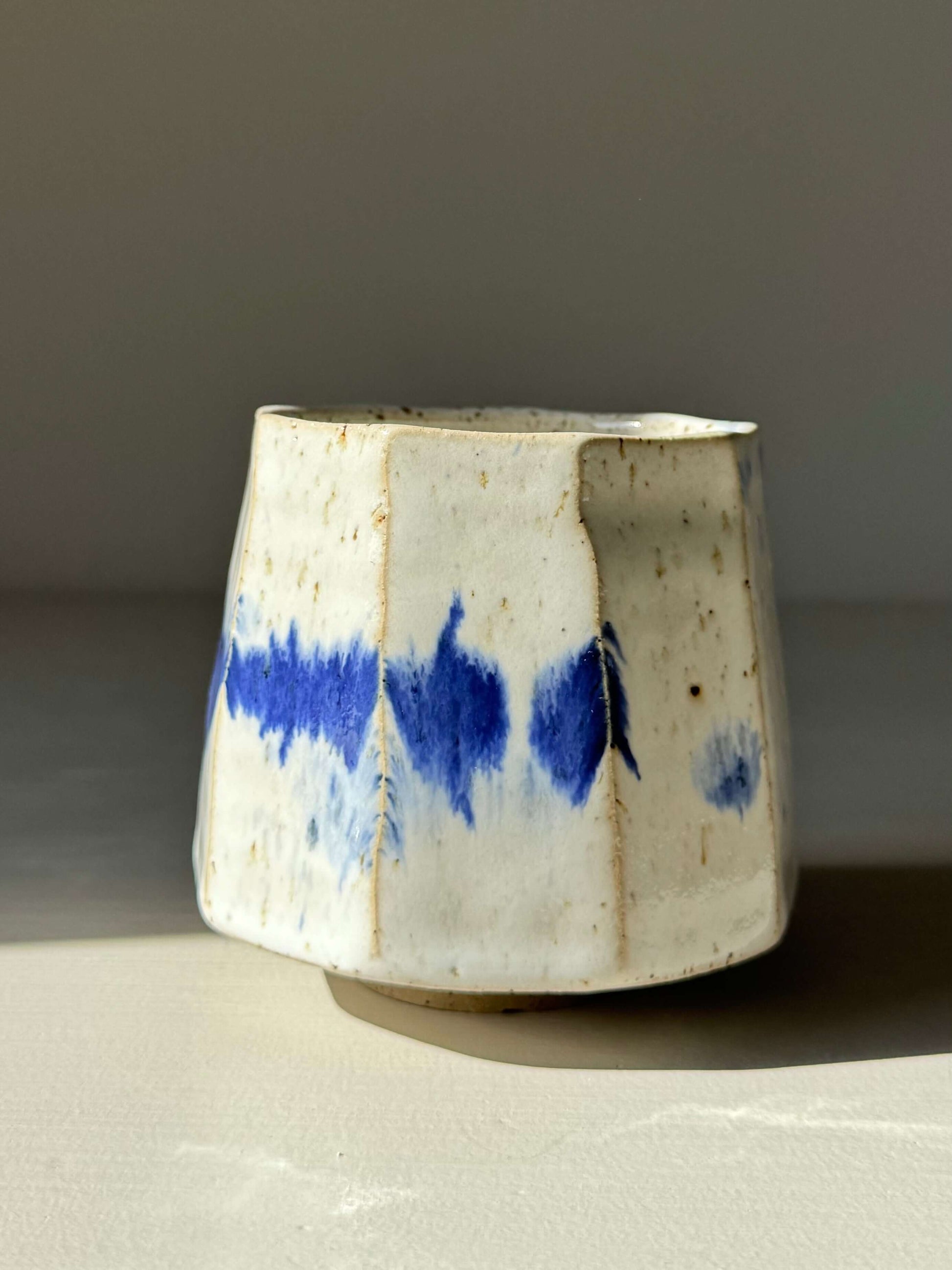 Handmade ceramic Faceted Cup – Cobalt Blue & Glossy White #02 with unique brushstrokes and angled design.