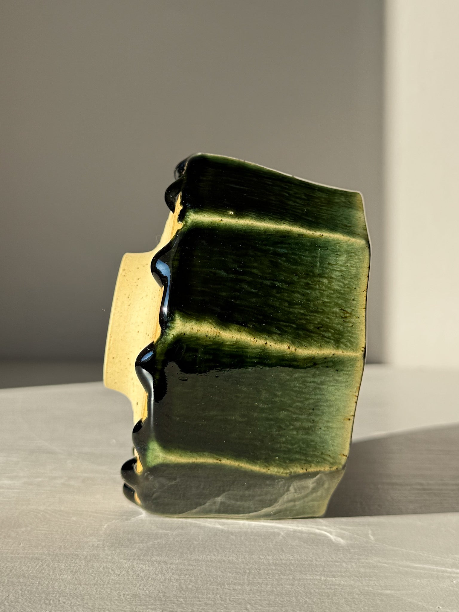 Side view of Faceted Matcha Bowl - Hinoki #02 with deep green glaze and carved lines
